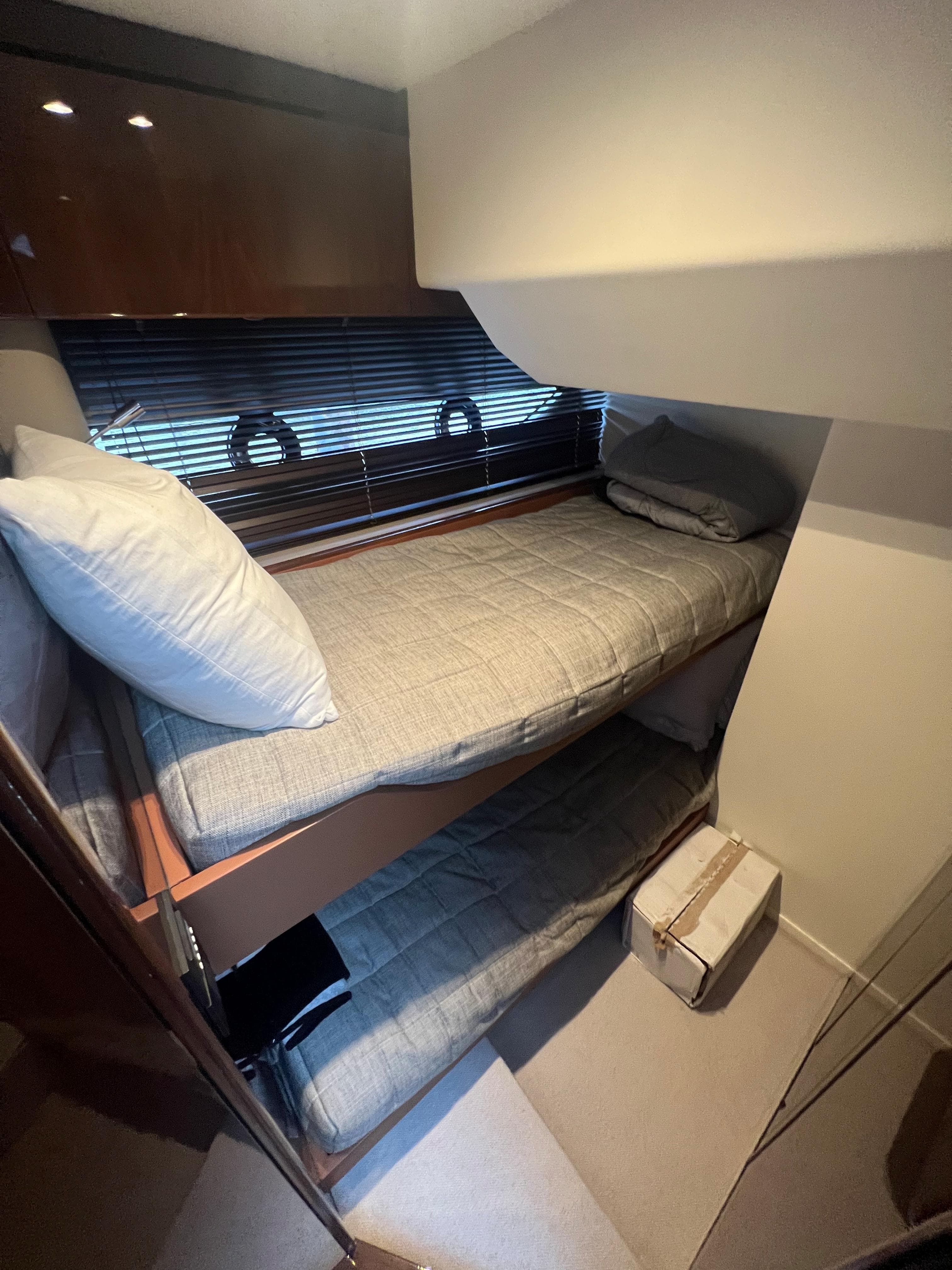 Cozy bunk beds in 2018 Princess V58 yacht cabin with modern decor.