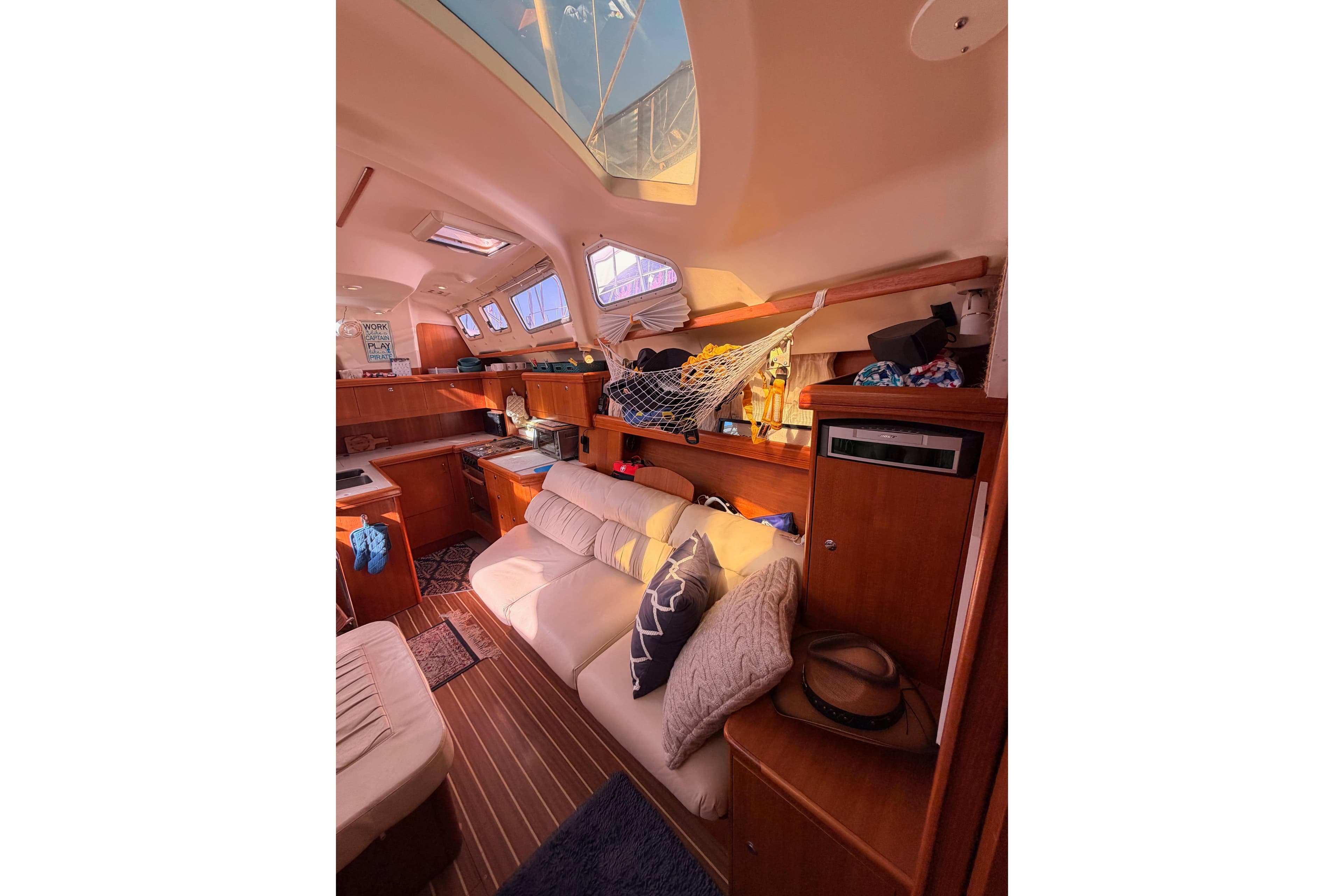 Interior of 2005 Hunter Passage 456 yacht with cozy seating and wooden cabinetry.