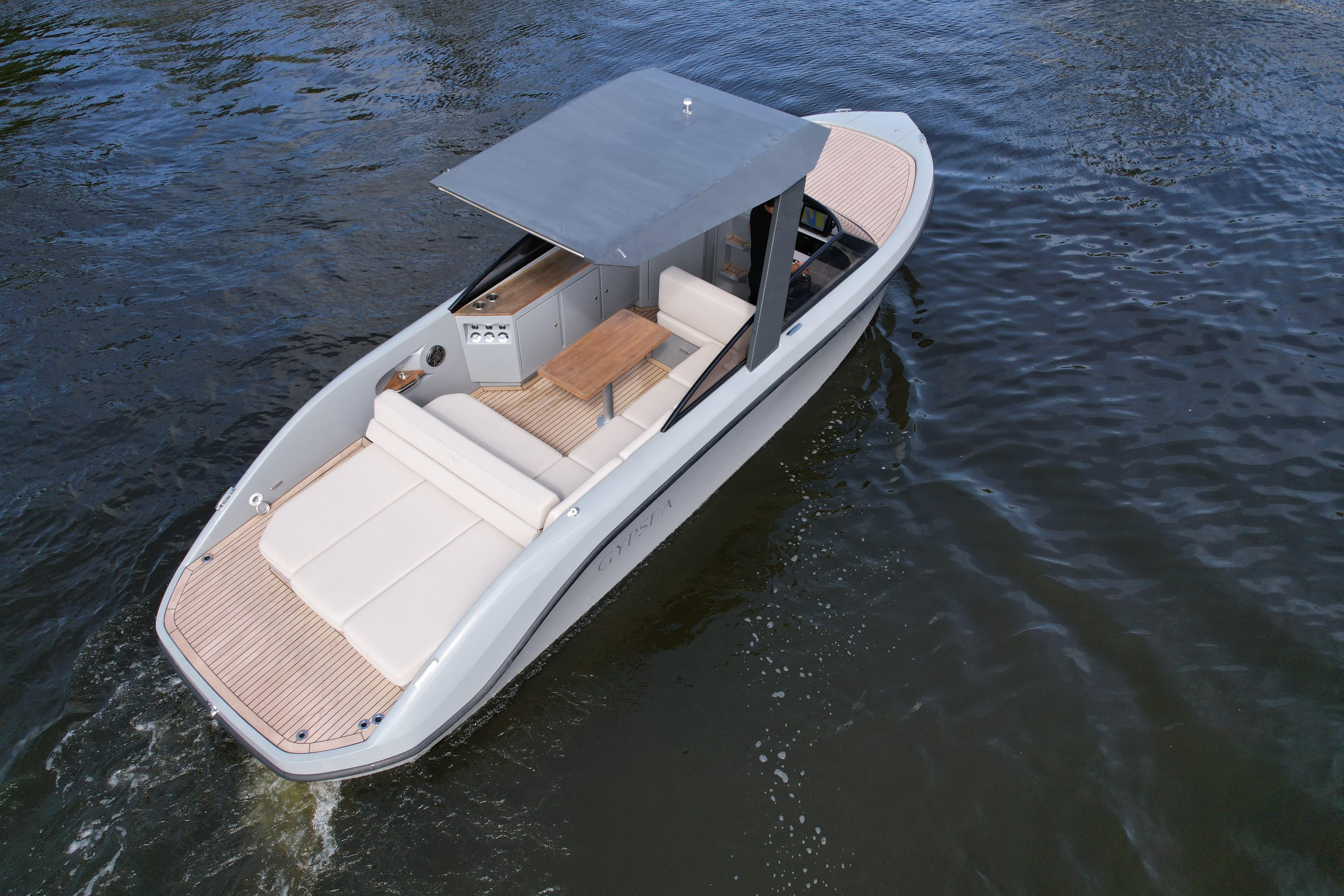 Modern 2021 Rand Leisure boat cruising on water, featuring sleek design and comfortable seating.
