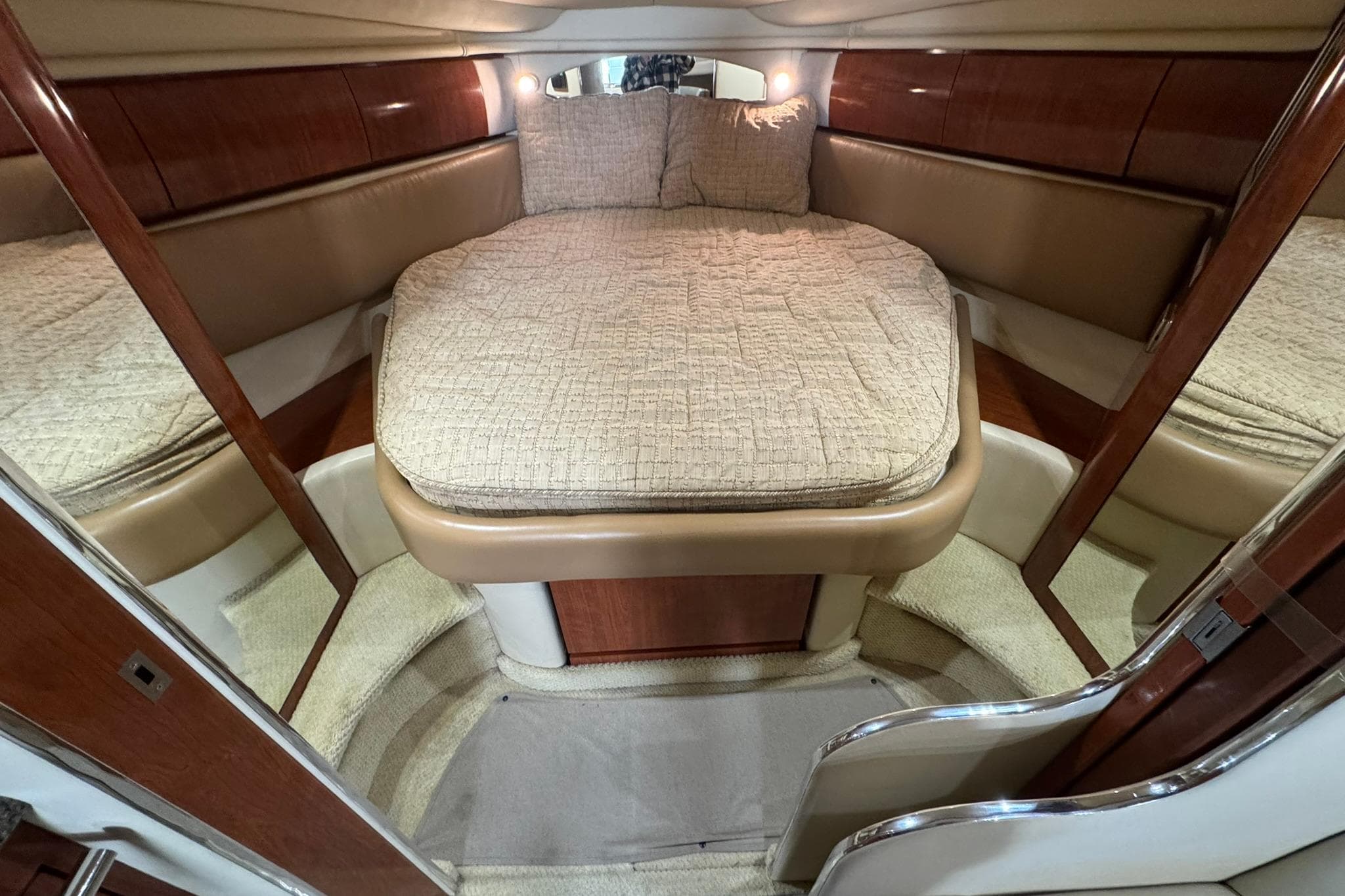 Luxurious cabin interior of 2005 Sea Ray 360 Sundancer yacht with cozy bed.