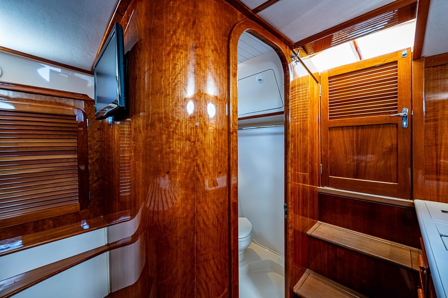 Luxurious wooden interior of 2013 Hinckley Picnic Boat 37 MKIII with elegant cabinetry and stairs.