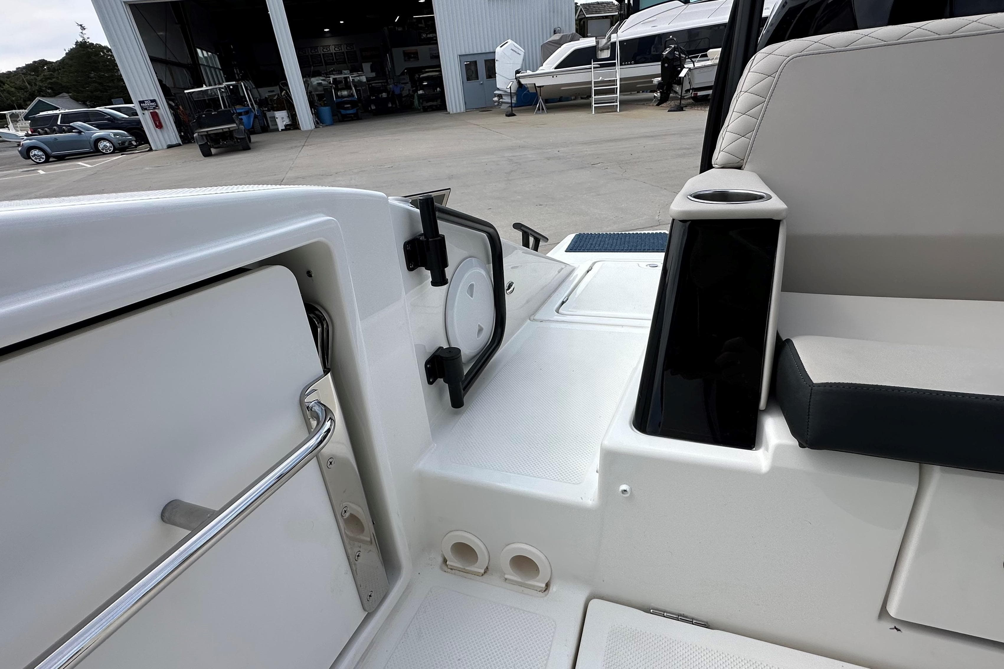 2025 Navan C30 boat interior with seating and storage, docked near a marina.