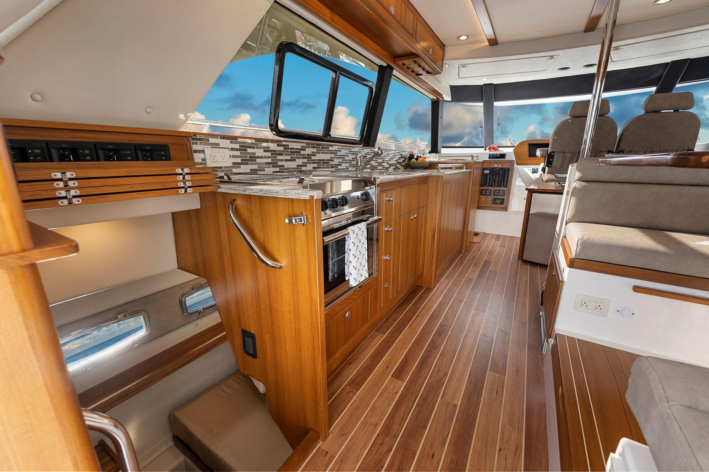 Luxurious interior of 2026 Aspen C120 Flybridge yacht with modern kitchen and seating area.