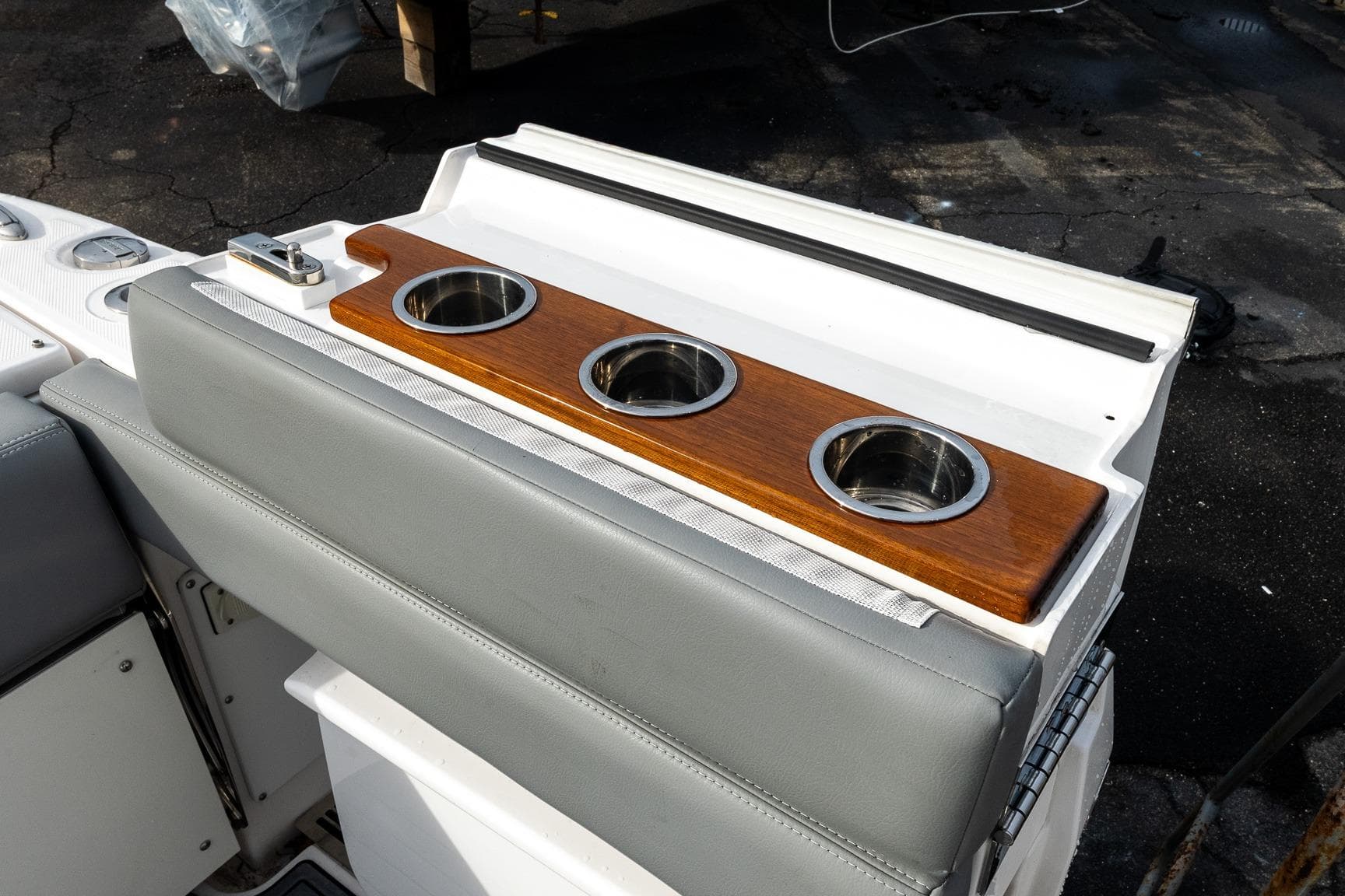 2023 Everglades 455 Center Console boat with wooden cup holders and cushioned seating.