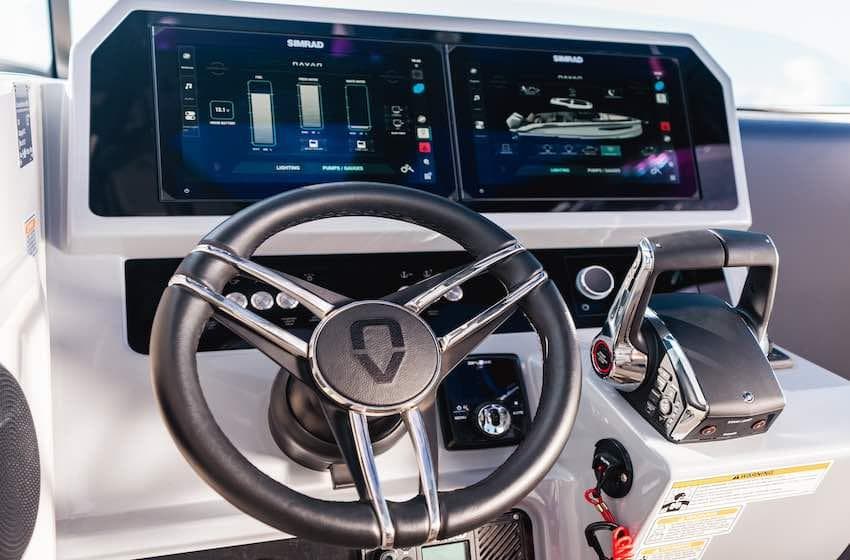 Steering wheel and control panel of 2025 Navan S30 boat with digital displays.