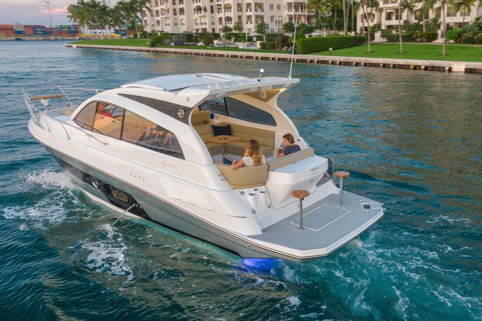 Luxurious 2026 Hanover 375 yacht cruising in a scenic waterfront setting.