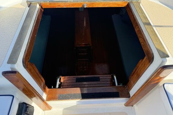 Companionway entrance of 1985 Endeavour 42 sailboat with wooden trim.