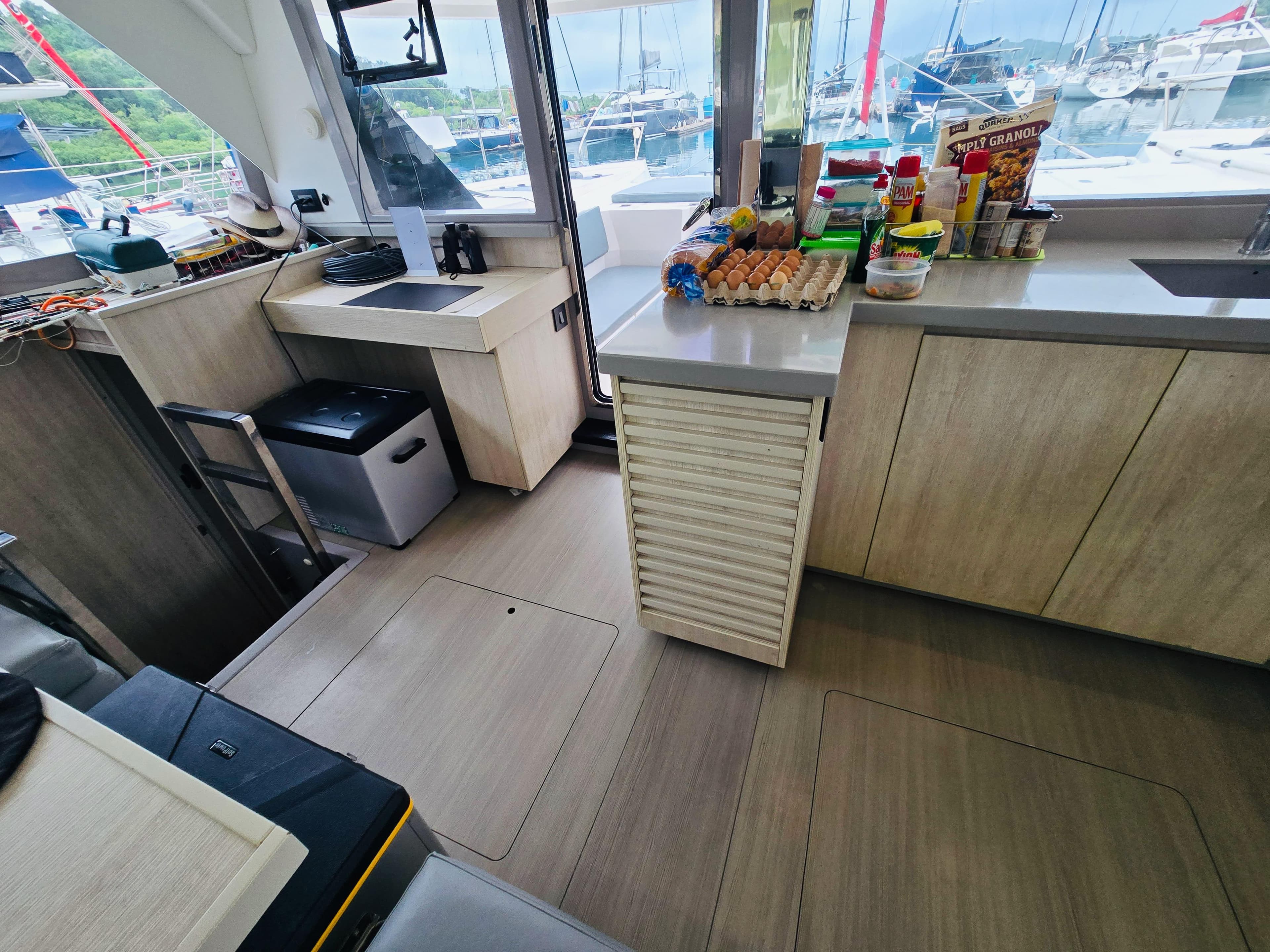 Modern kitchen interior on a 2018 Leopard 45 yacht, featuring wooden cabinetry and countertop essentials.