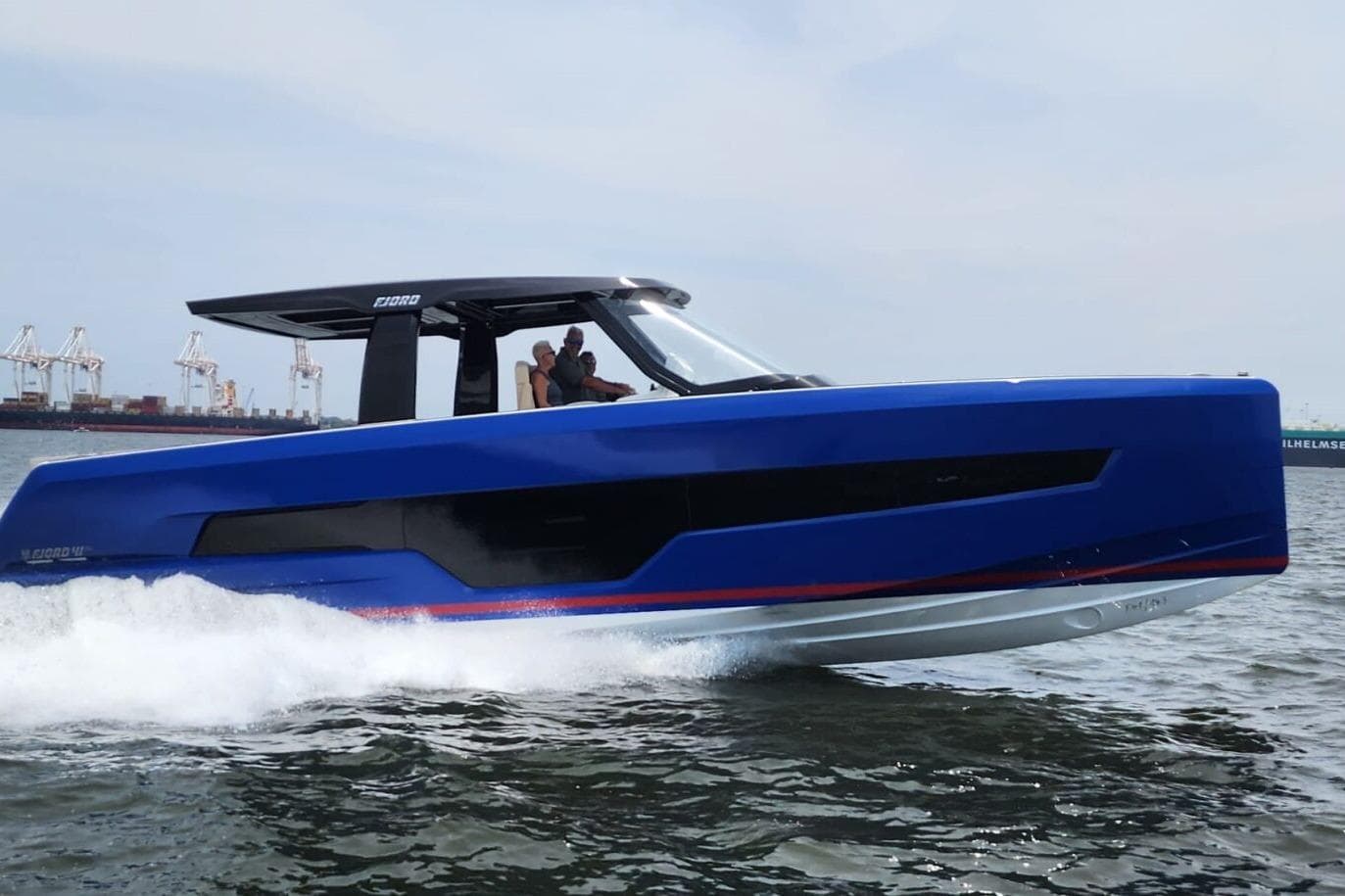 2023 Fjord 41 XL boat cruising on water, showcasing sleek blue design.