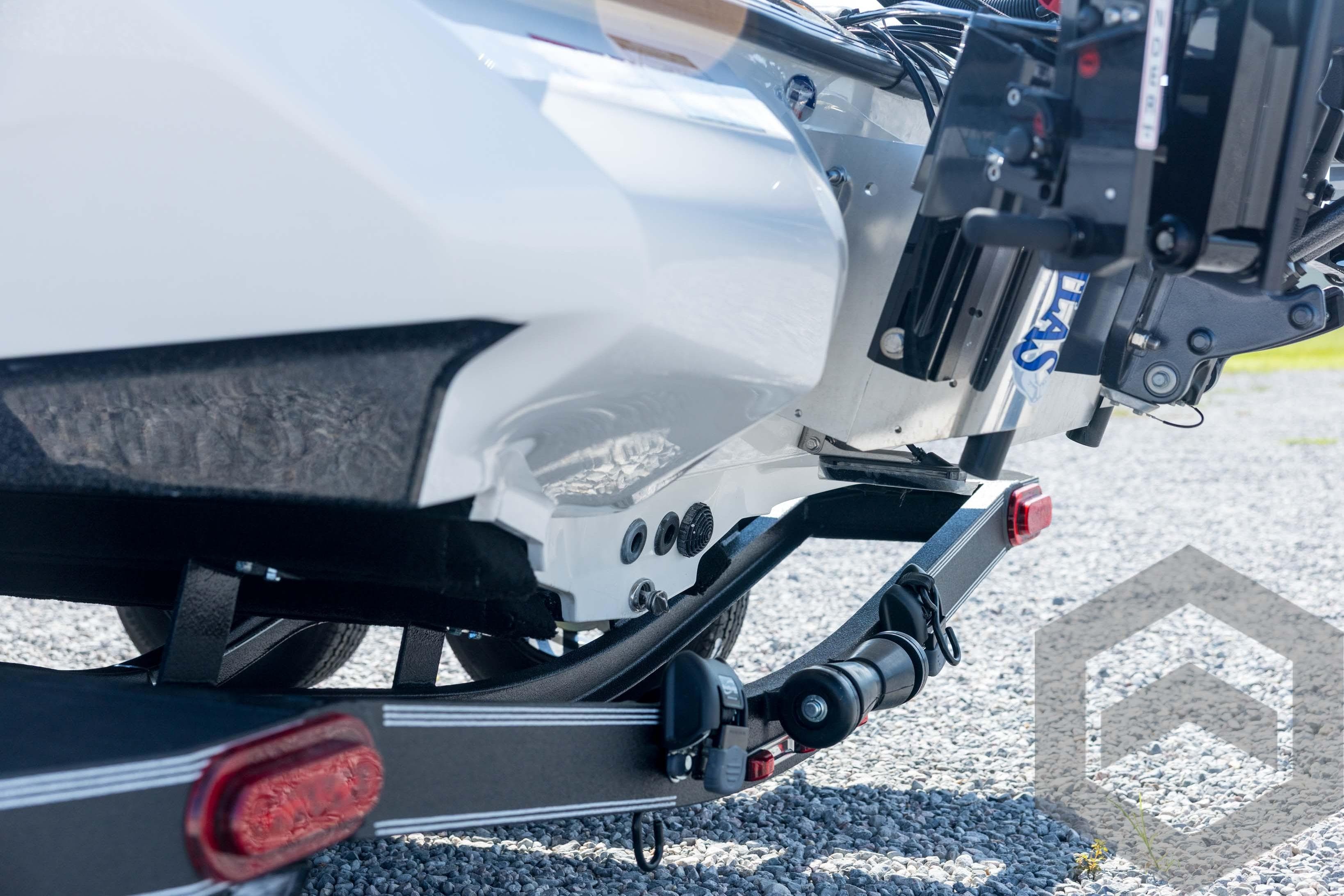 2026 Skeeter ZXE21 boat trailer detail on gravel surface.