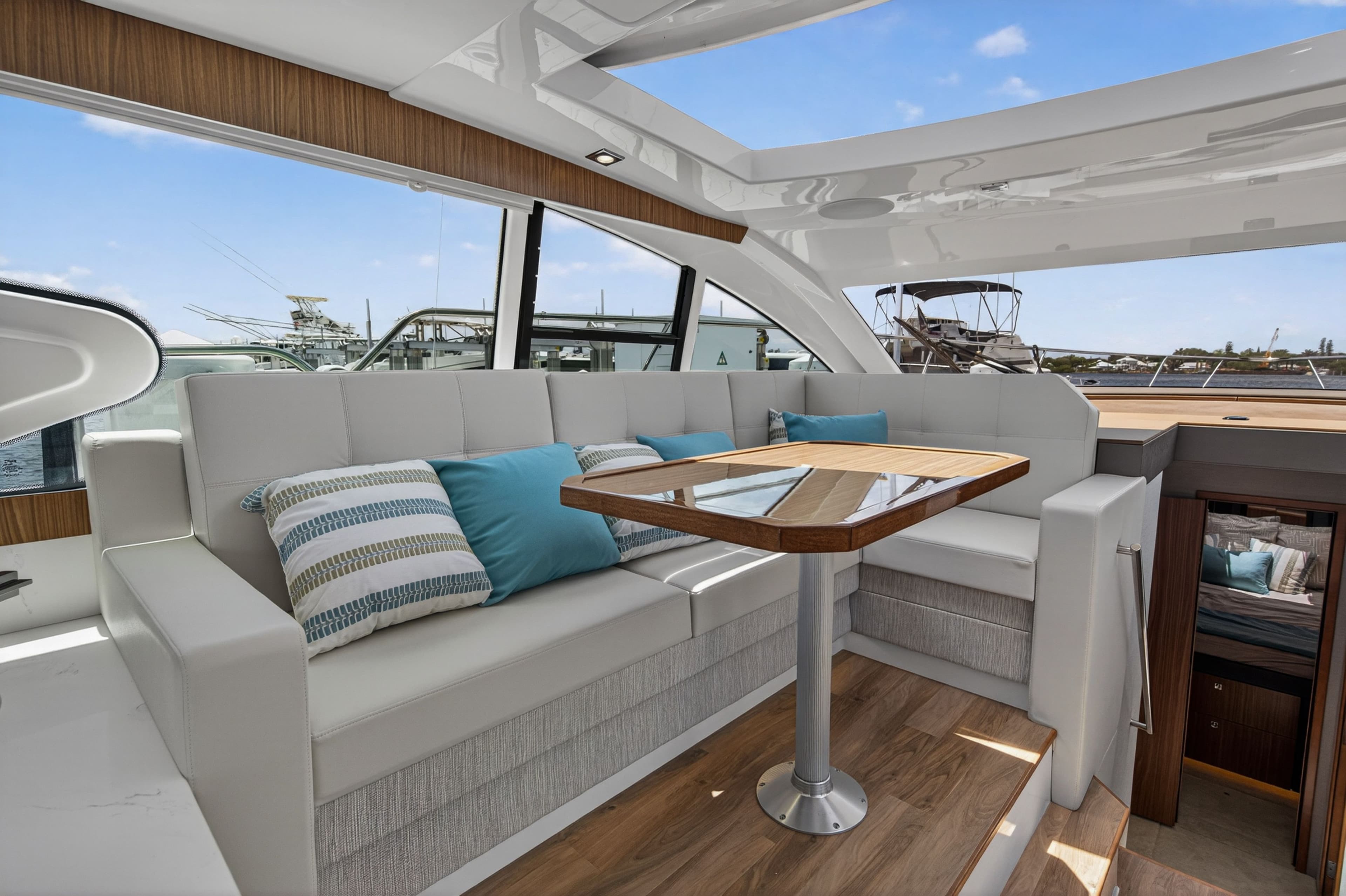 Interior of 2026 Cruisers Yachts 46 Cantius with stylish sofa and table.