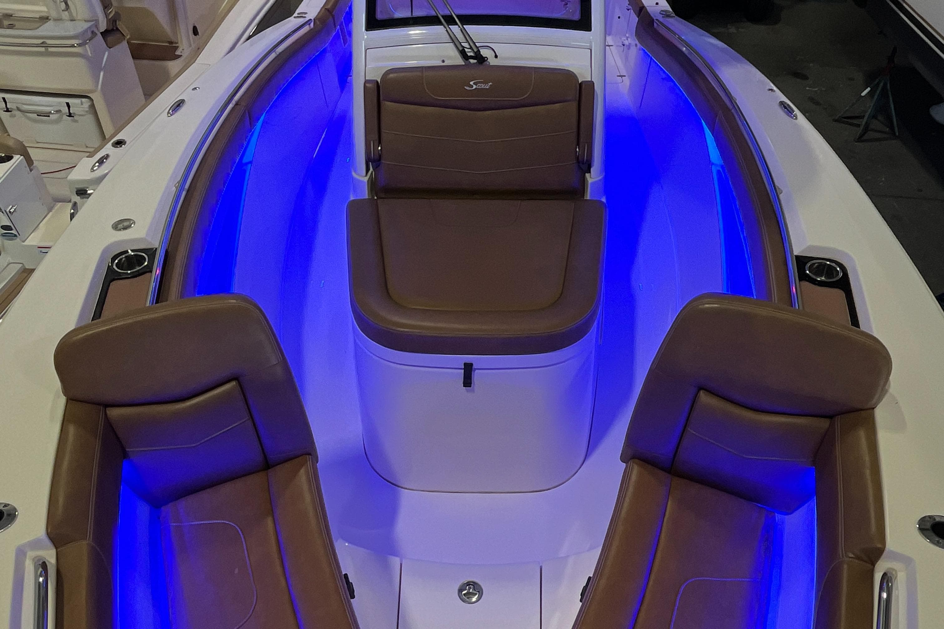 2021 Scout 305 LXF boat interior with blue LED lighting and brown seating.