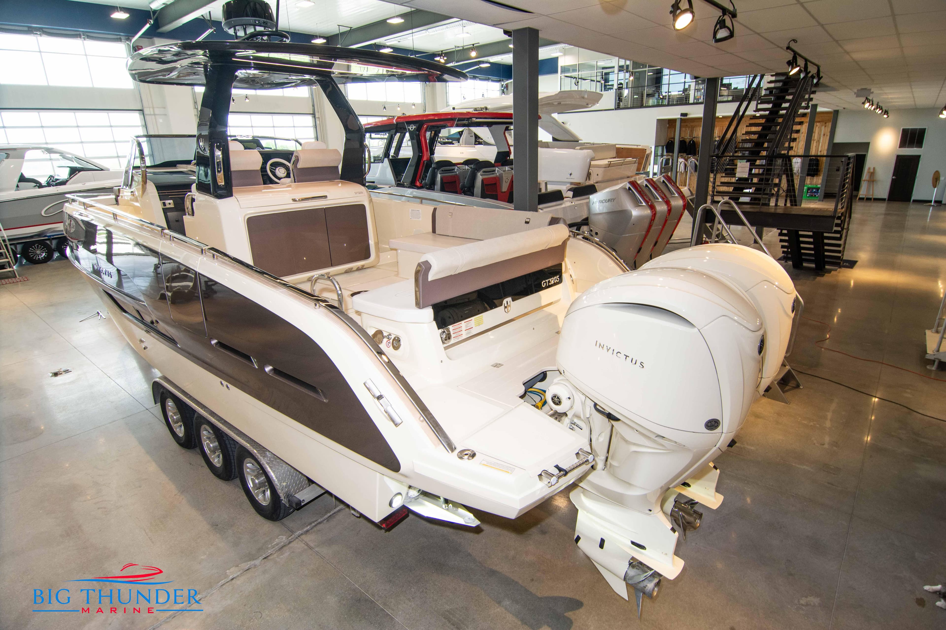 2024 Invictus GT320S luxury motorboat displayed in a showroom.