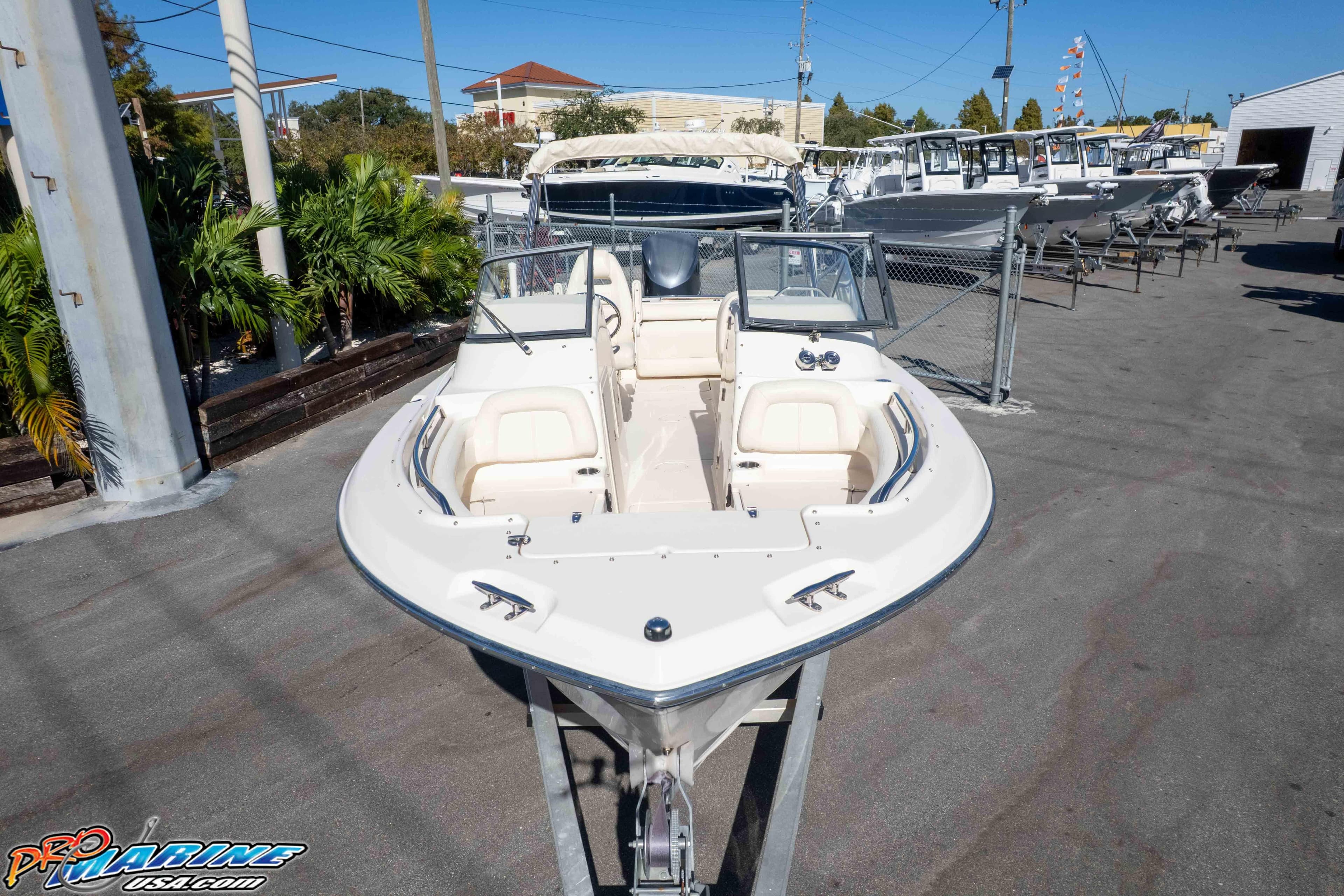 2016 Grady-White Freedom 225 boat displayed at a marina, surrounded by other vessels.