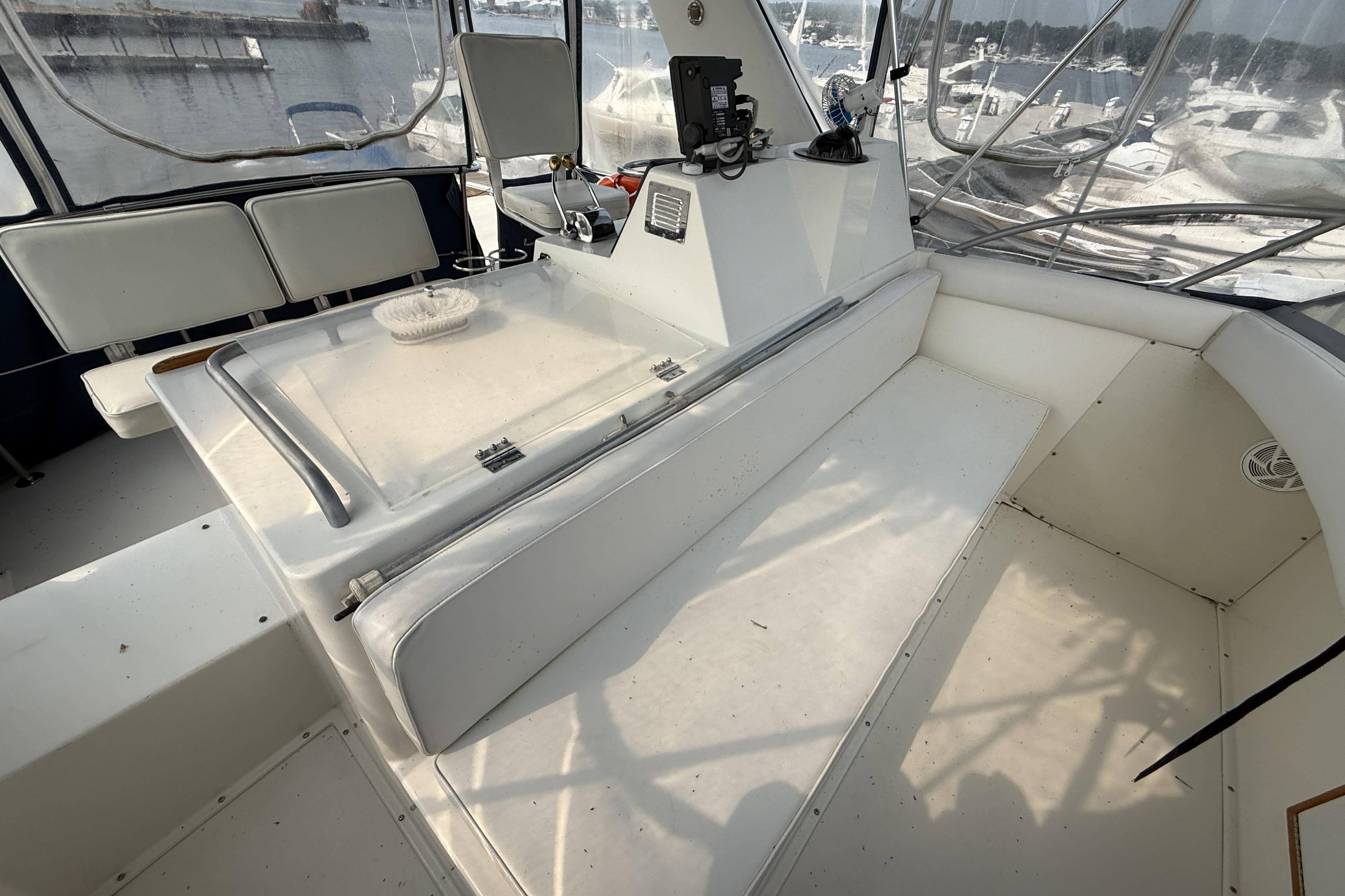 1978 Bertram 42 Convertible boat interior with white seating and control panel.