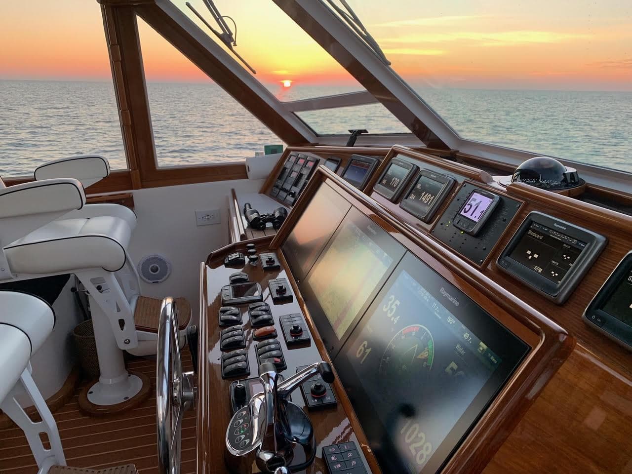 1998 Viking 54 Sport Yacht helm with sunset view over the ocean.