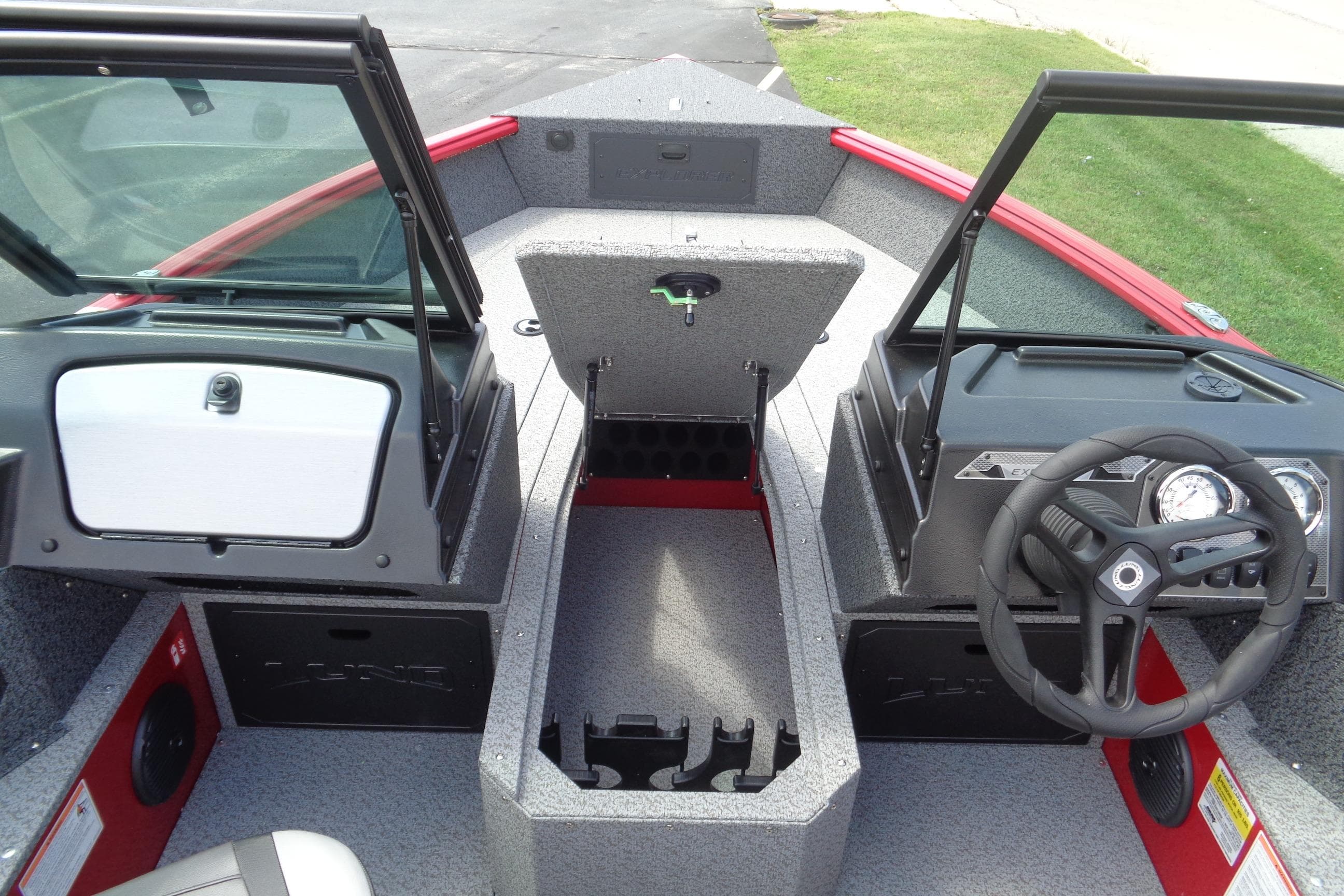 2026 Lund 1800 Explorer Sport boat interior with steering wheel and storage compartments.