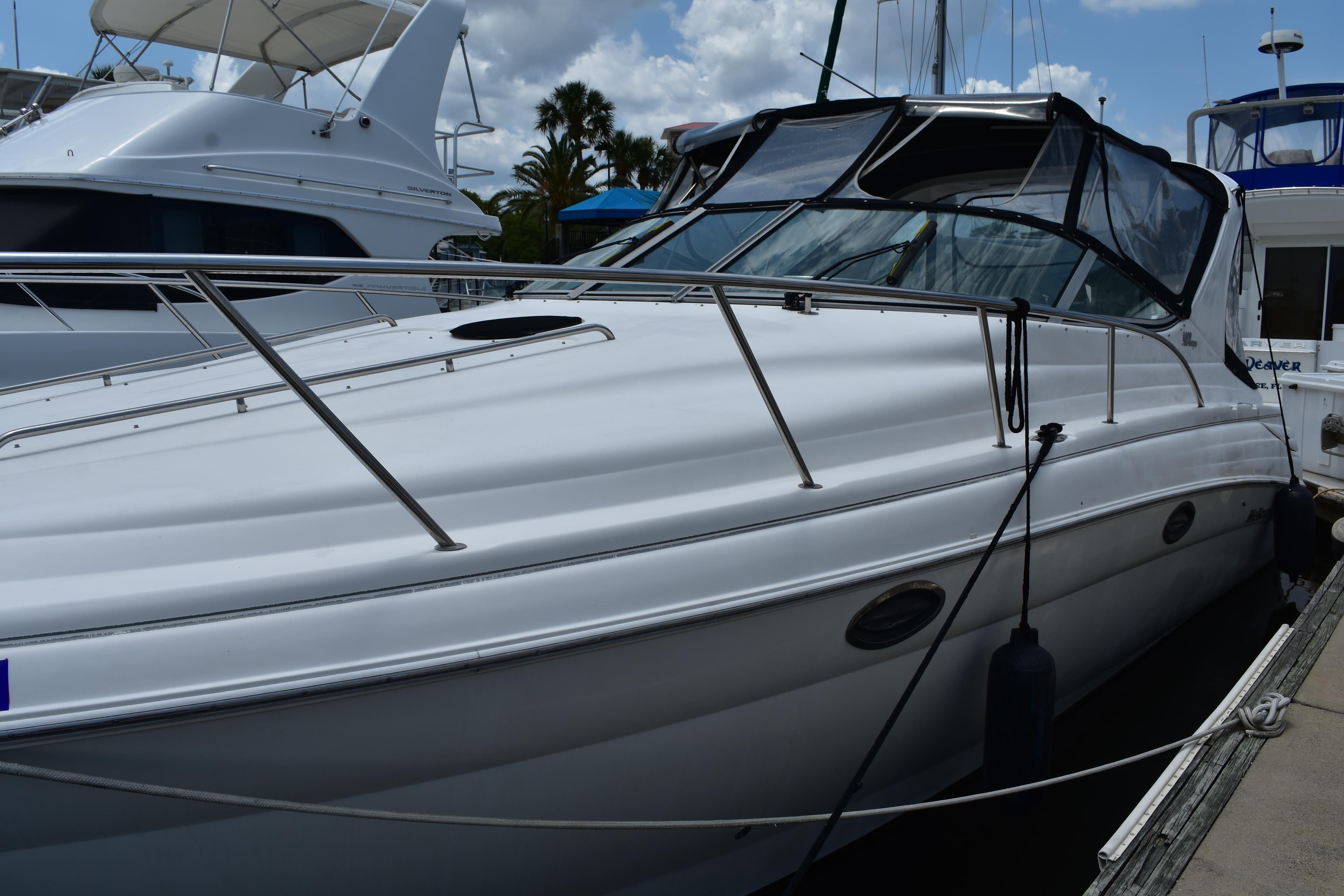 2003 Wellcraft 3300 Martinique boat docked, featuring sleek design and spacious deck.