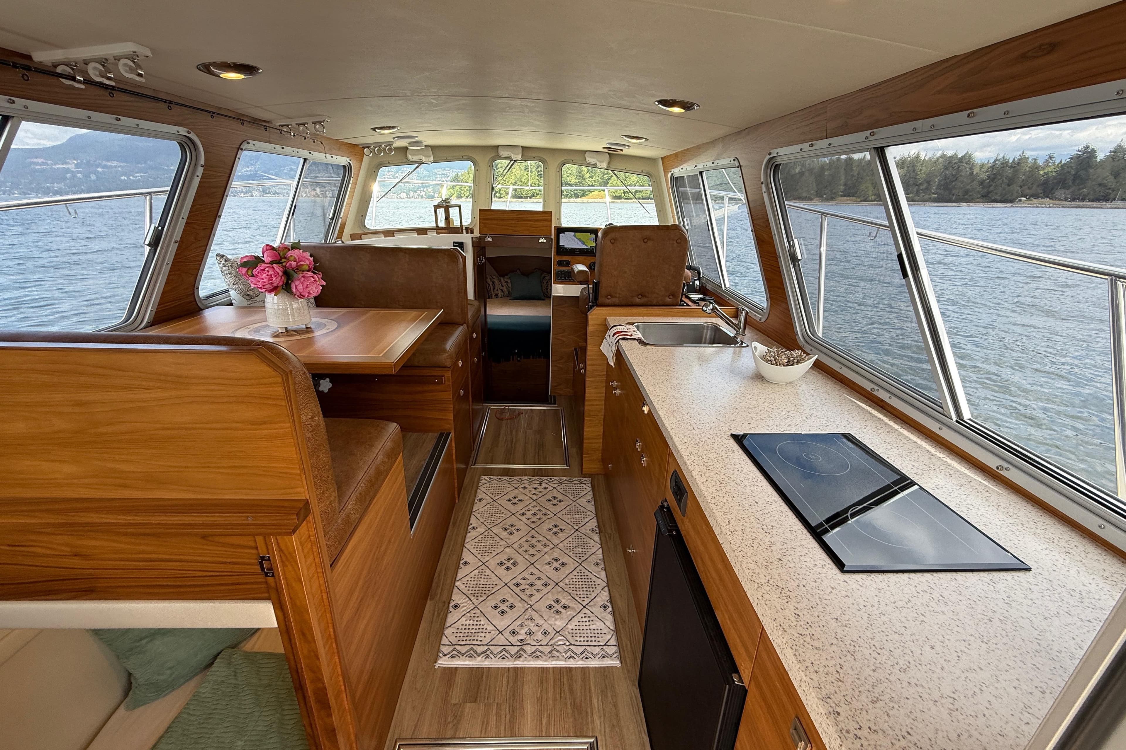 Interior of 2020 Coastal Craft 33 ProFish boat with wood finish and modern amenities.