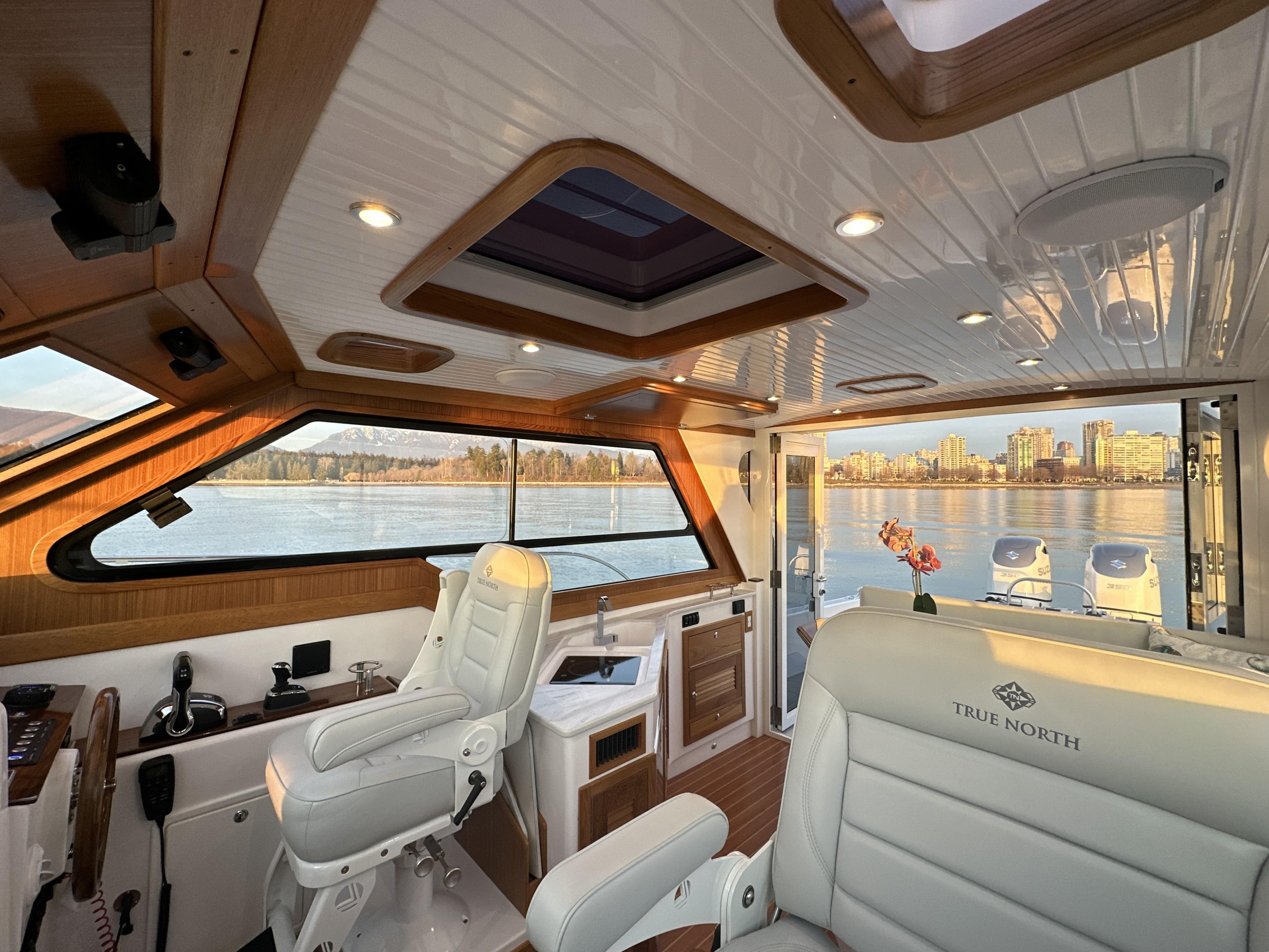 Interior of 2025 True North 34 Outboard Express boat with luxurious seating and scenic view.