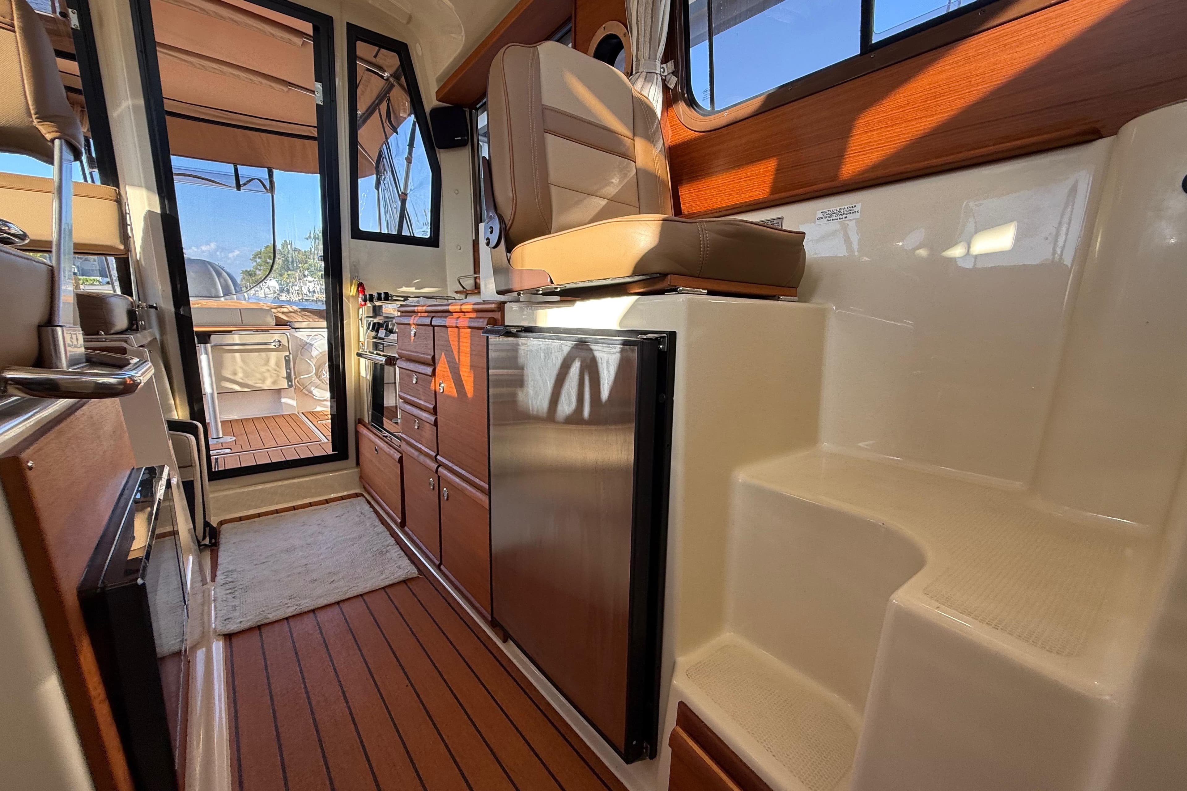 Interior of 2022 Ranger Tugs R-27 boat with wood accents and seating.