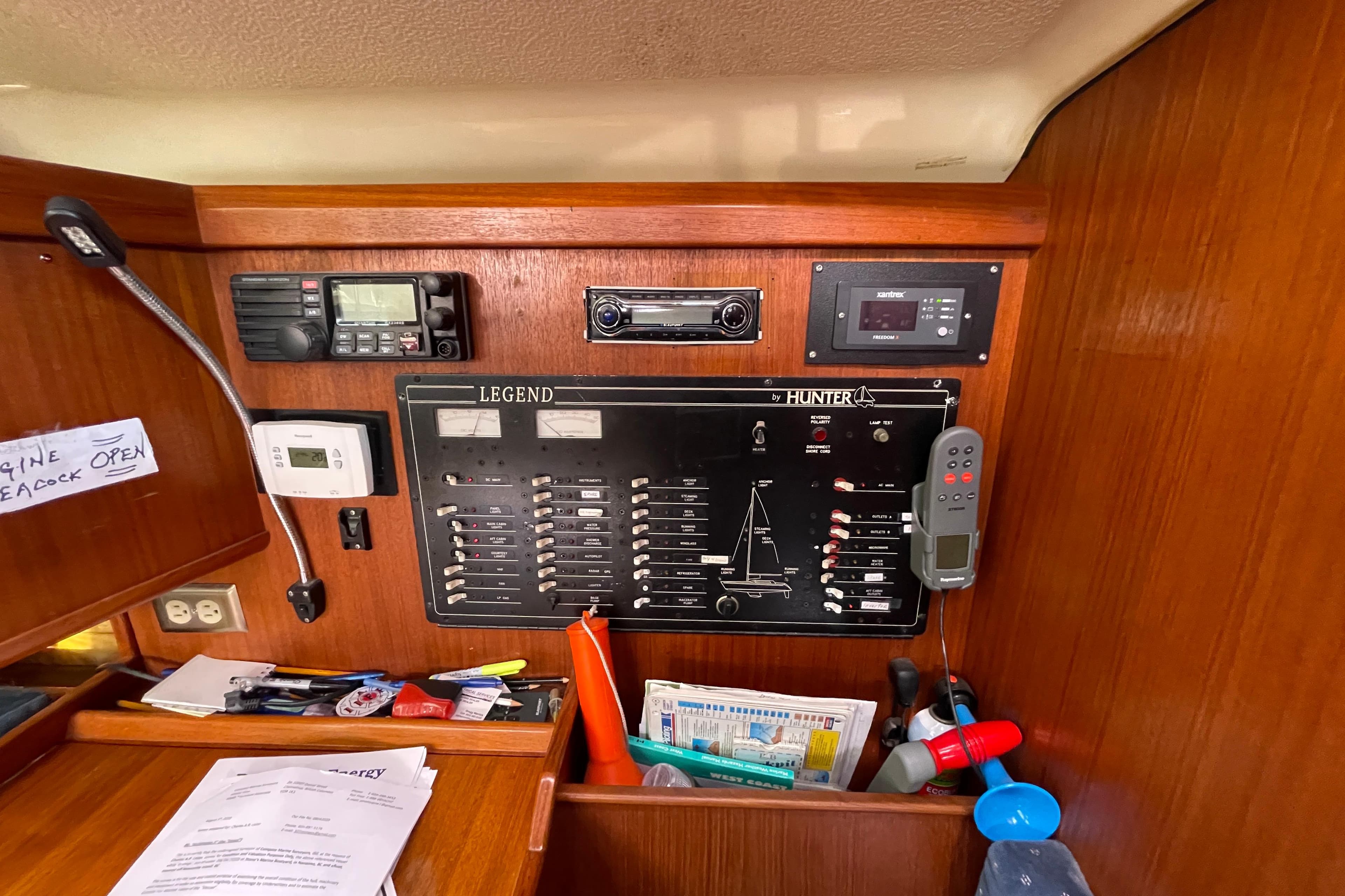 Control panel of a 1995 Hunter Legend 40.5 sailboat with navigation and communication equipment.
