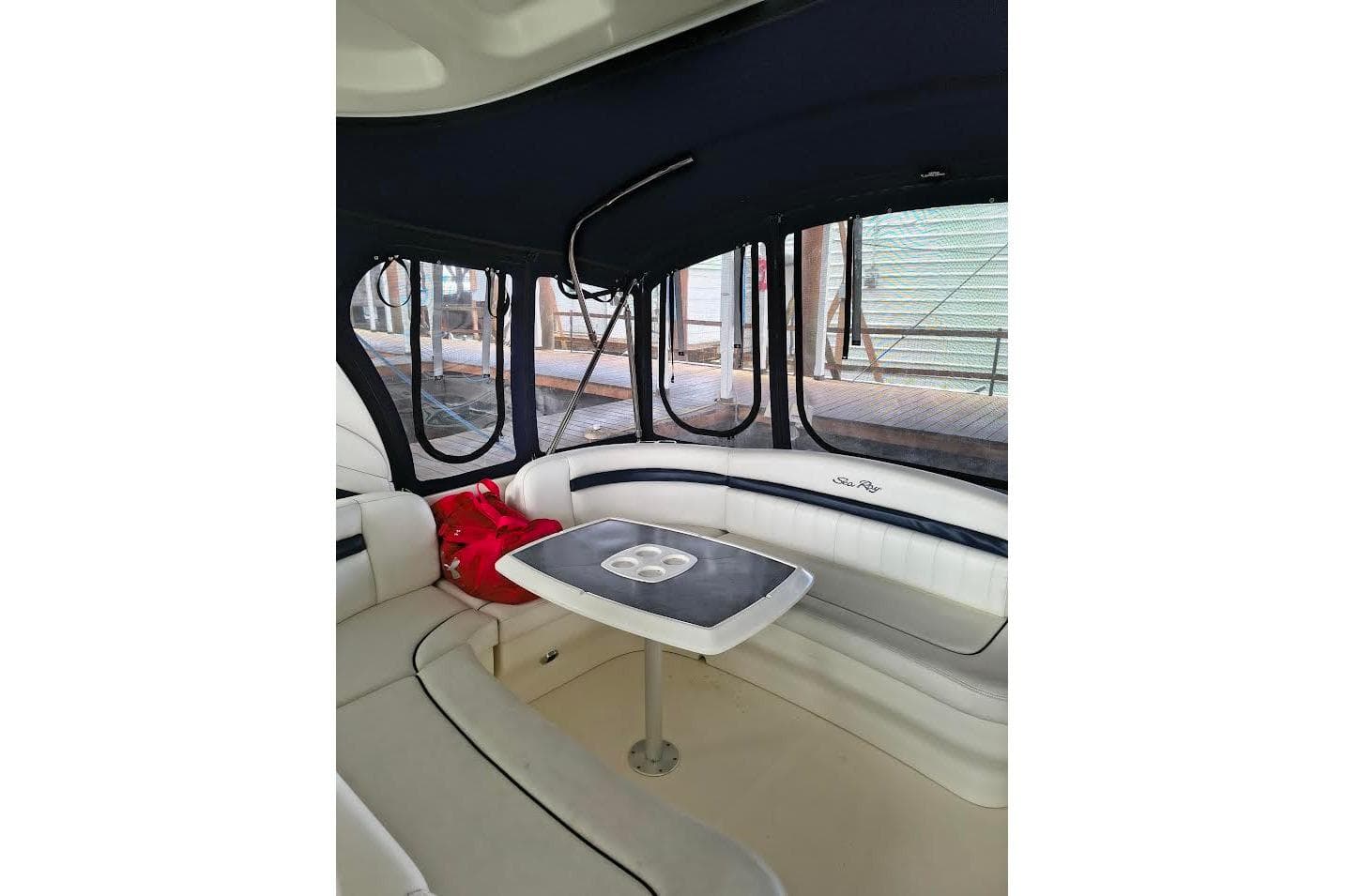 Interior of 2005 Sea Ray 390 Sundancer yacht with seating and table.