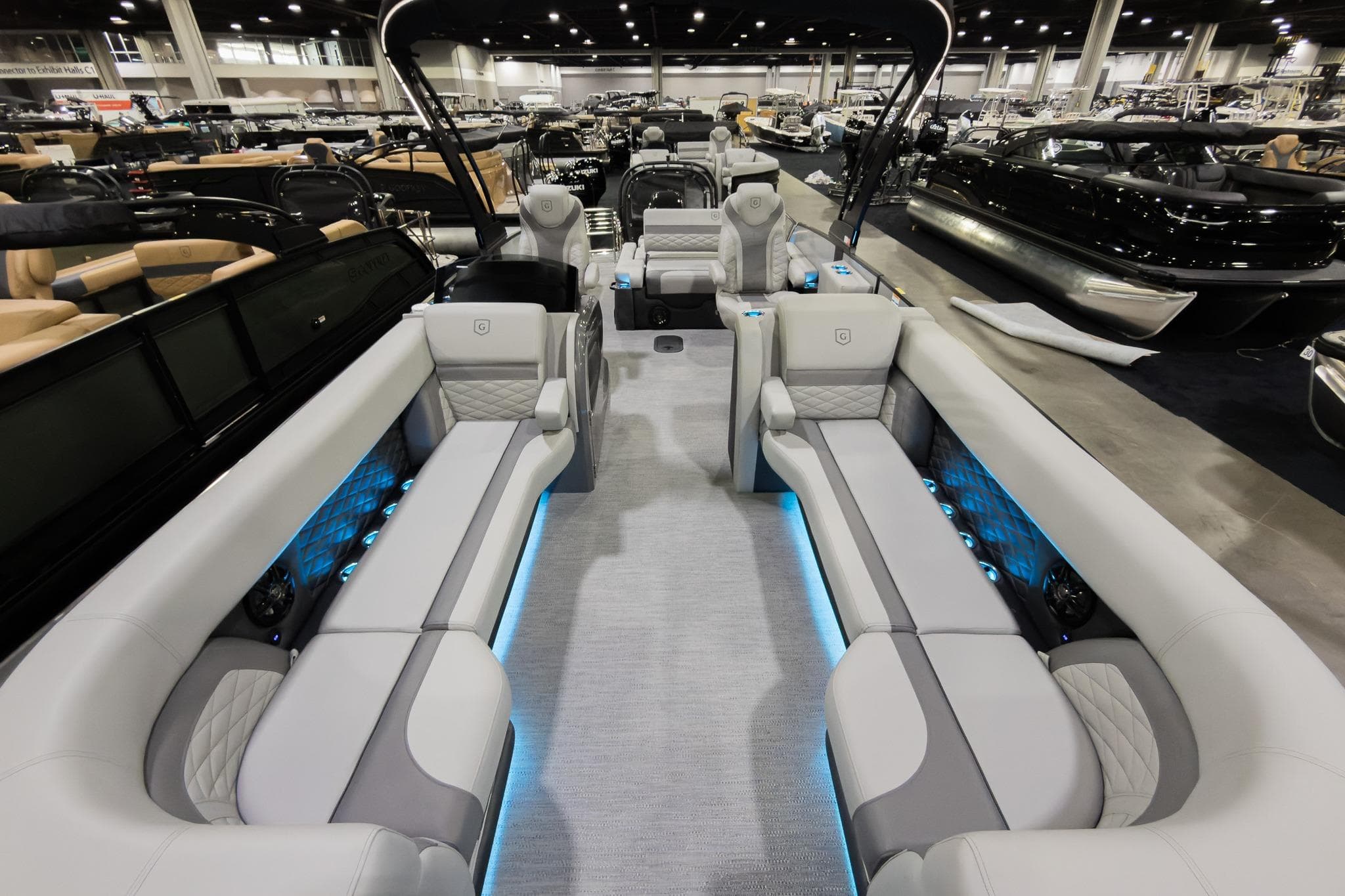 2026 Godfrey Monaco 25' Tritoon interior with luxurious seating and ambient lighting.