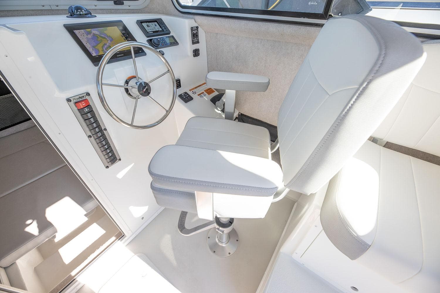 Manufacturer Provided Image: 2026 Parker 257 Explorer boat helm with steering wheel and navigation controls.