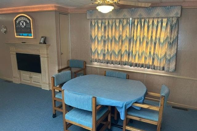Interior of a 1992 Lakeview houseboat with dining table and fireplace.