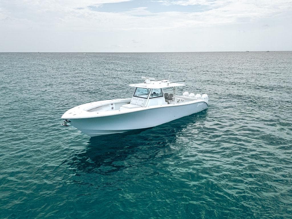 2019 Yellowfin 42 boat on calm ocean waters under a cloudy sky.