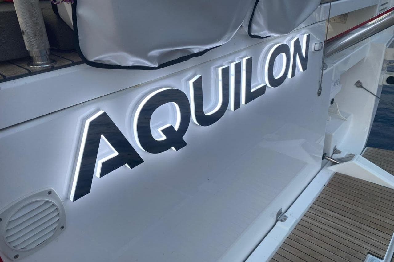 Dufour 530 yacht, 2021 model, featuring illuminated "AQUILON" name on the stern.