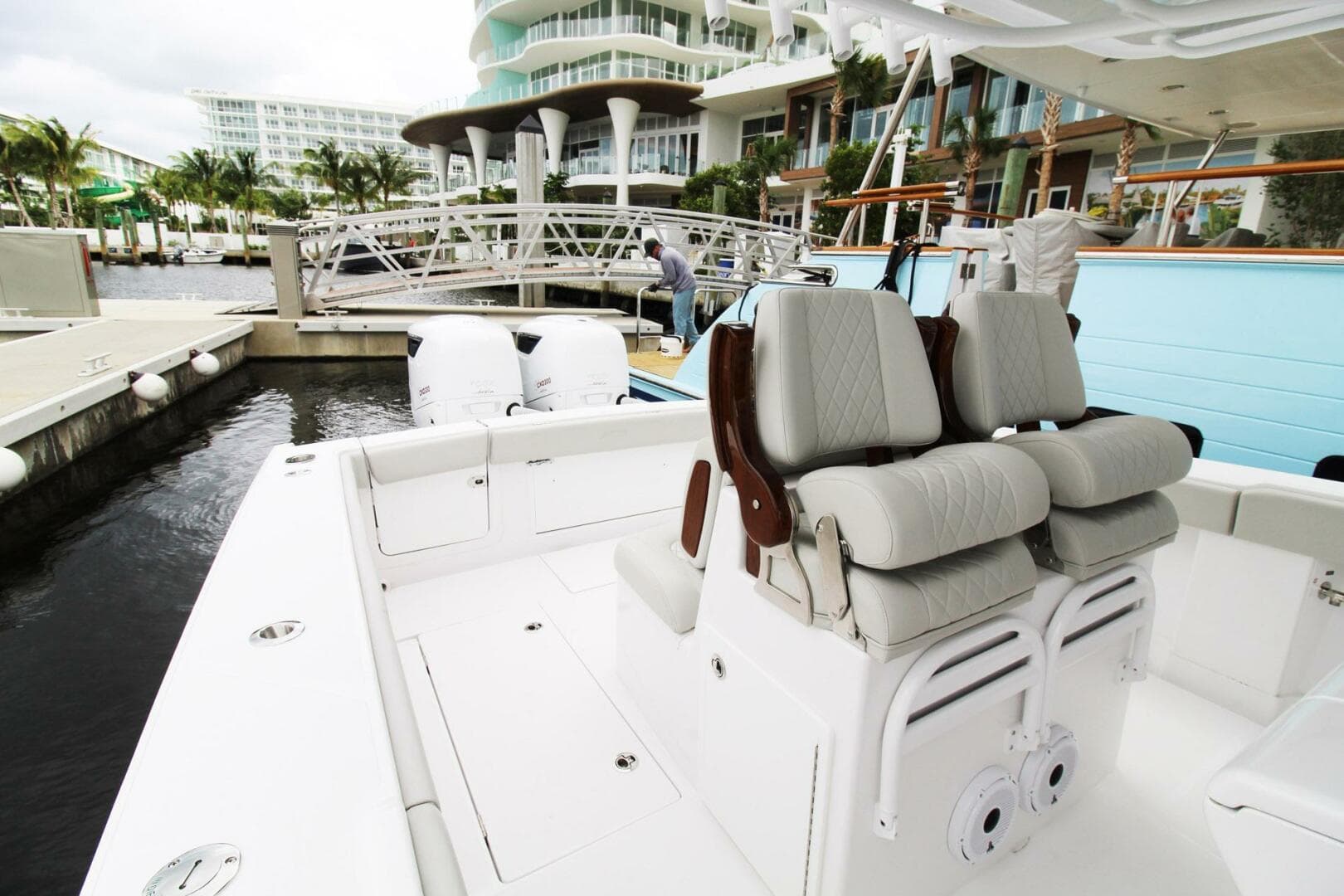 2024 Jupiter 34 HFS boat with luxurious seating at a marina.