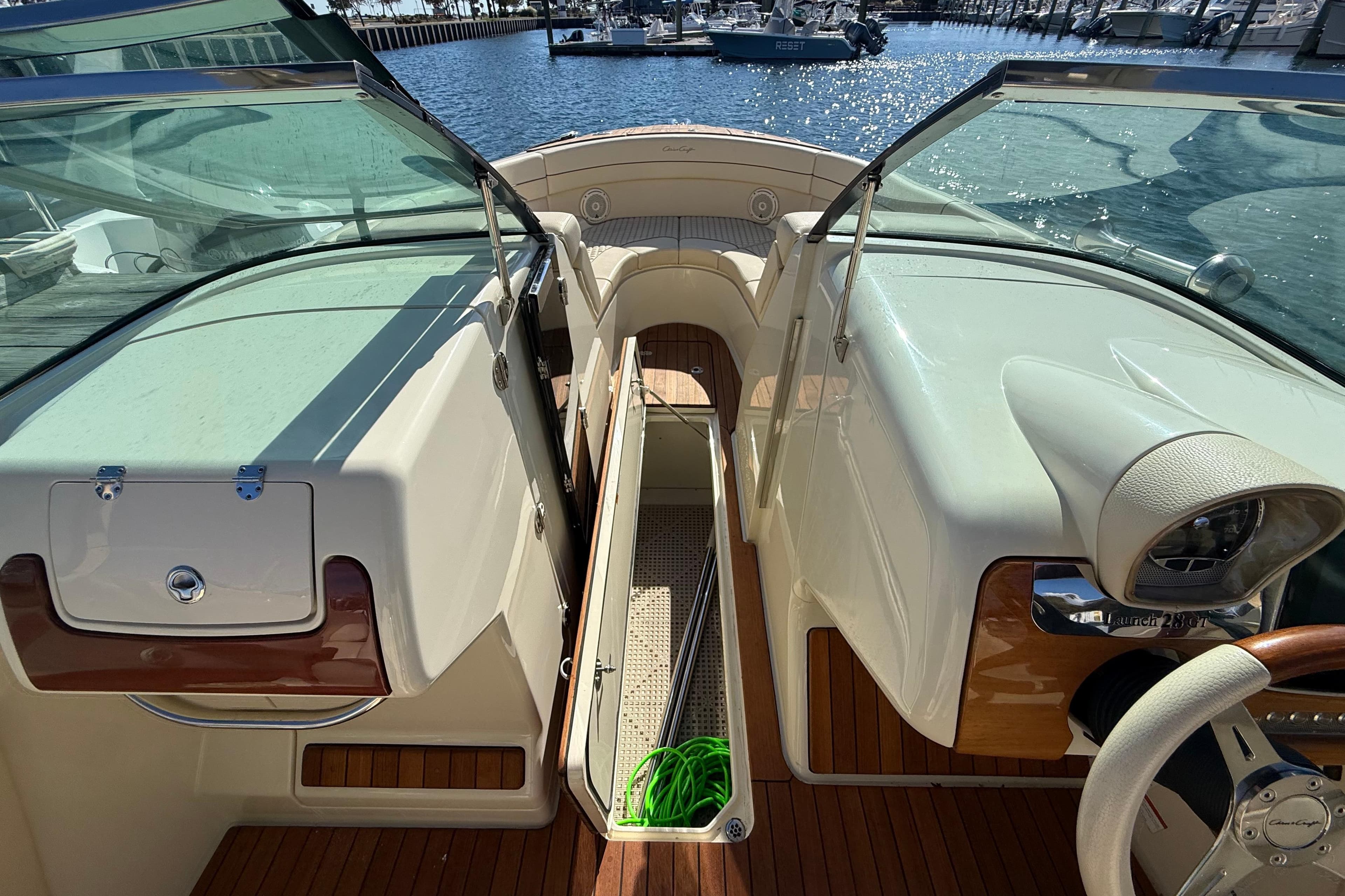 2019 Chris-Craft Launch 28 GT interior with open deck and marina view.