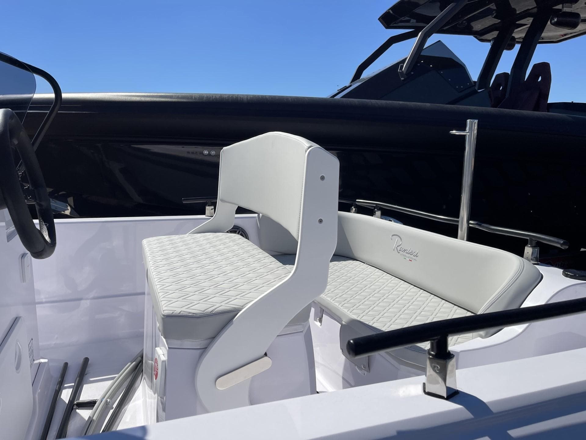 2024 Ranieri Voyager 19S boat interior with white seating and steering wheel.