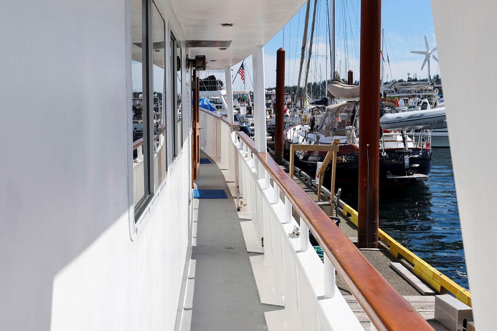 Side view of a 1935 Vintage Fenner & Hood Heritage Cruiser docked at a marina.