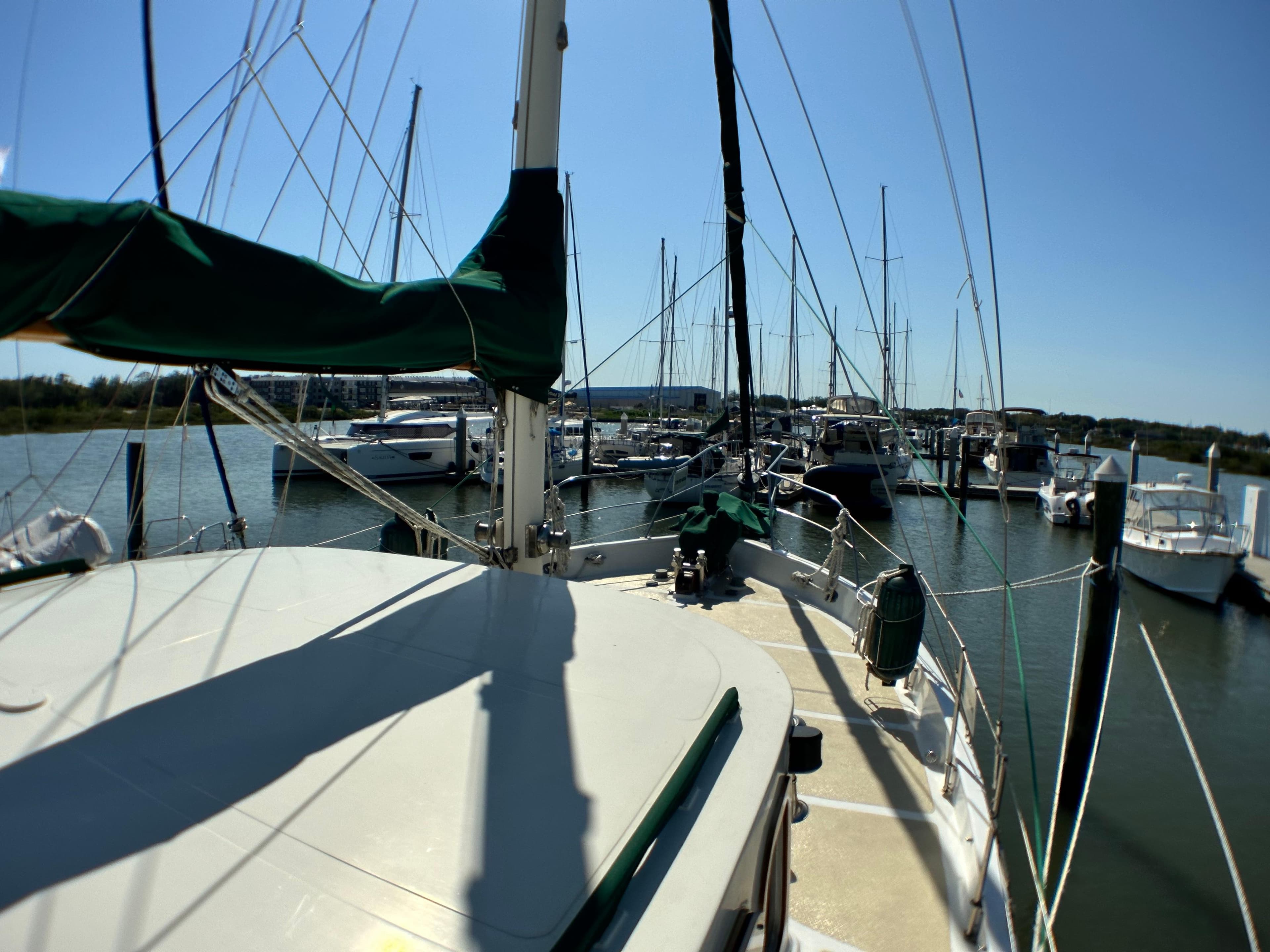 Sailboat docked in marina, Island Trader 46, 1981 model, sunny day, calm waters.