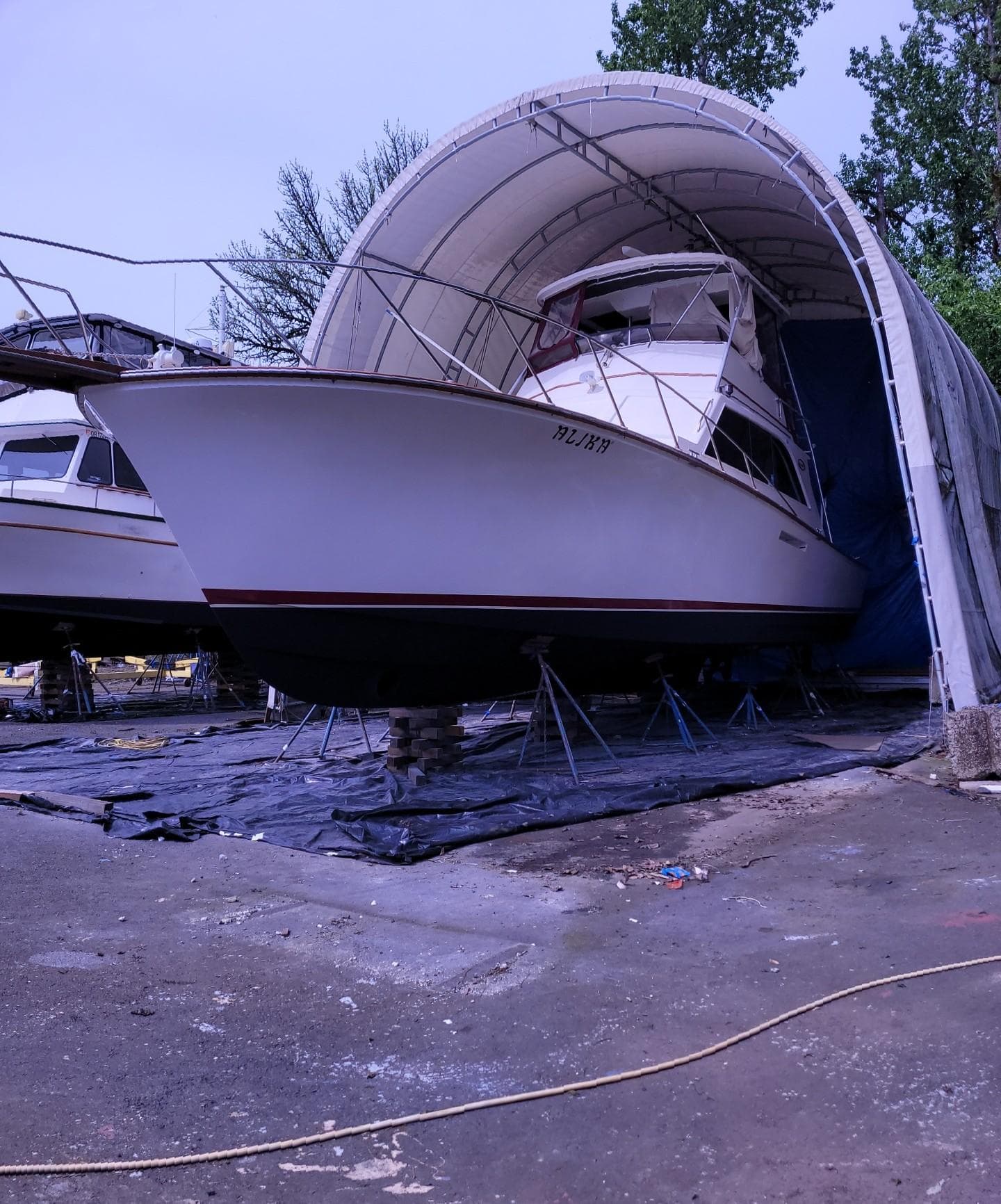 1983 Ocean Yachts Super Sport boat in dry dock under a protective canopy.
