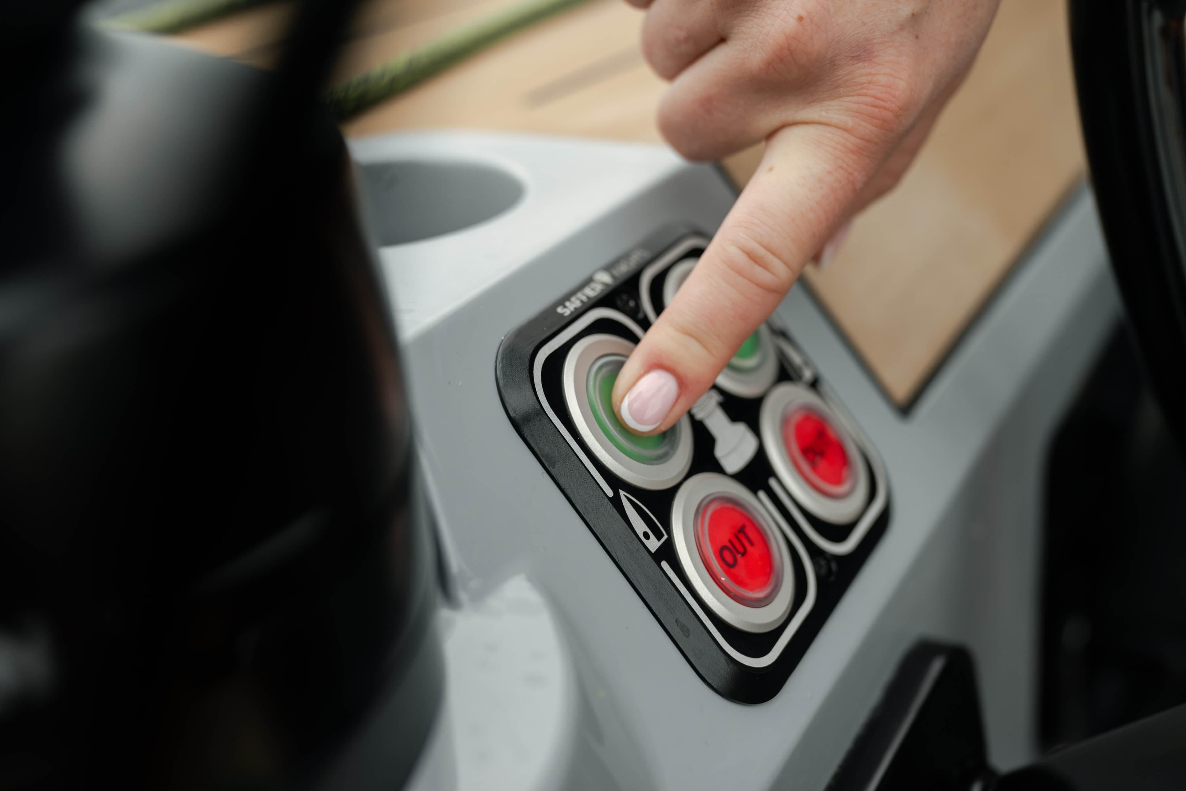 Finger pressing button on 2026 Saffier SE 28 Leopard control panel.