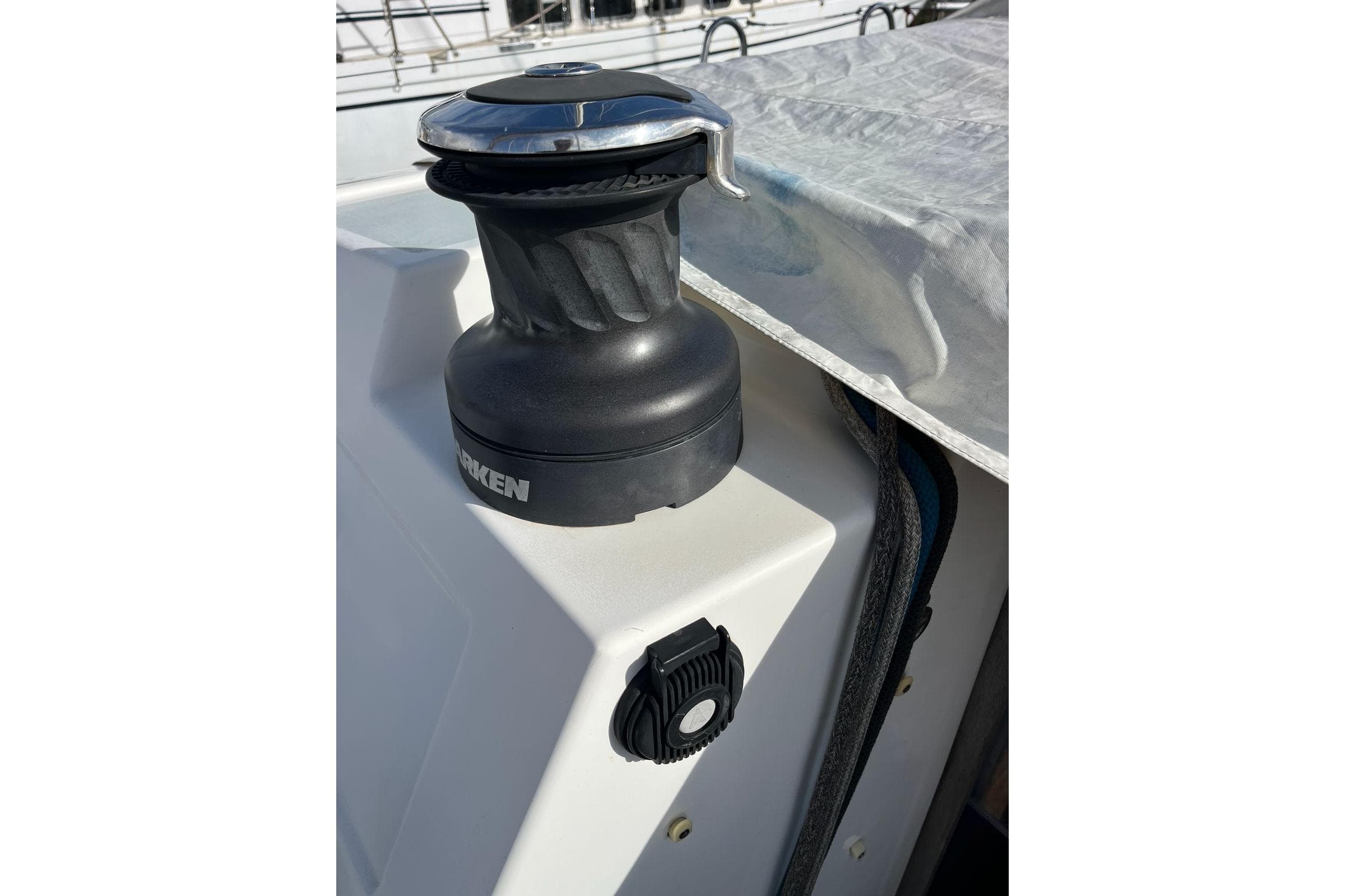 Winch on 2013 RM Yachts 1260 sailboat deck, covered with tarp.