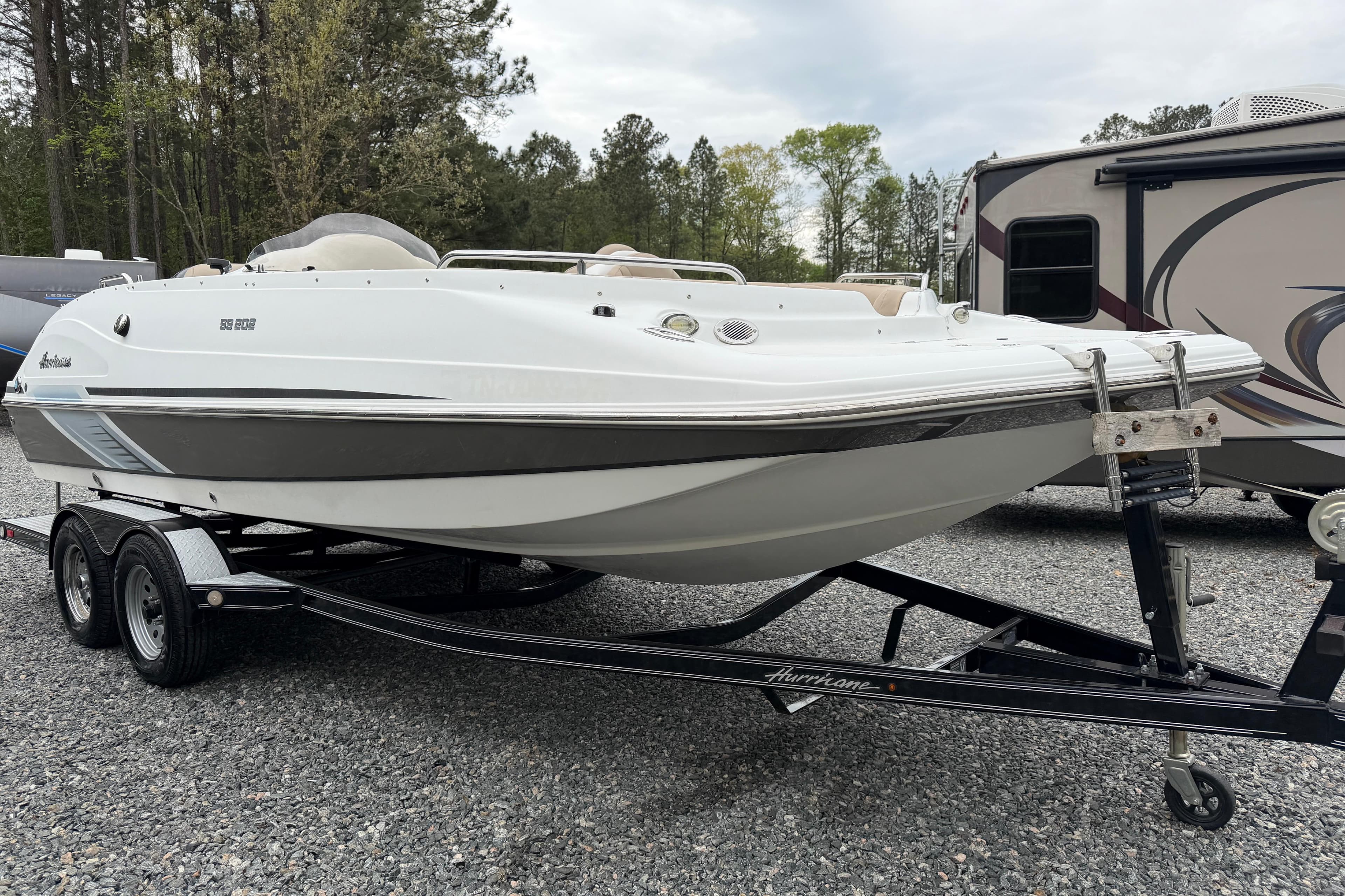 2016 Hurricane SunDeck Sport 202 OB boat on trailer, parked outdoors.