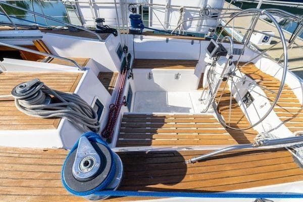 Cockpit of 1989 Wauquiez Centurion 47 sailboat with wooden deck and steering wheel.