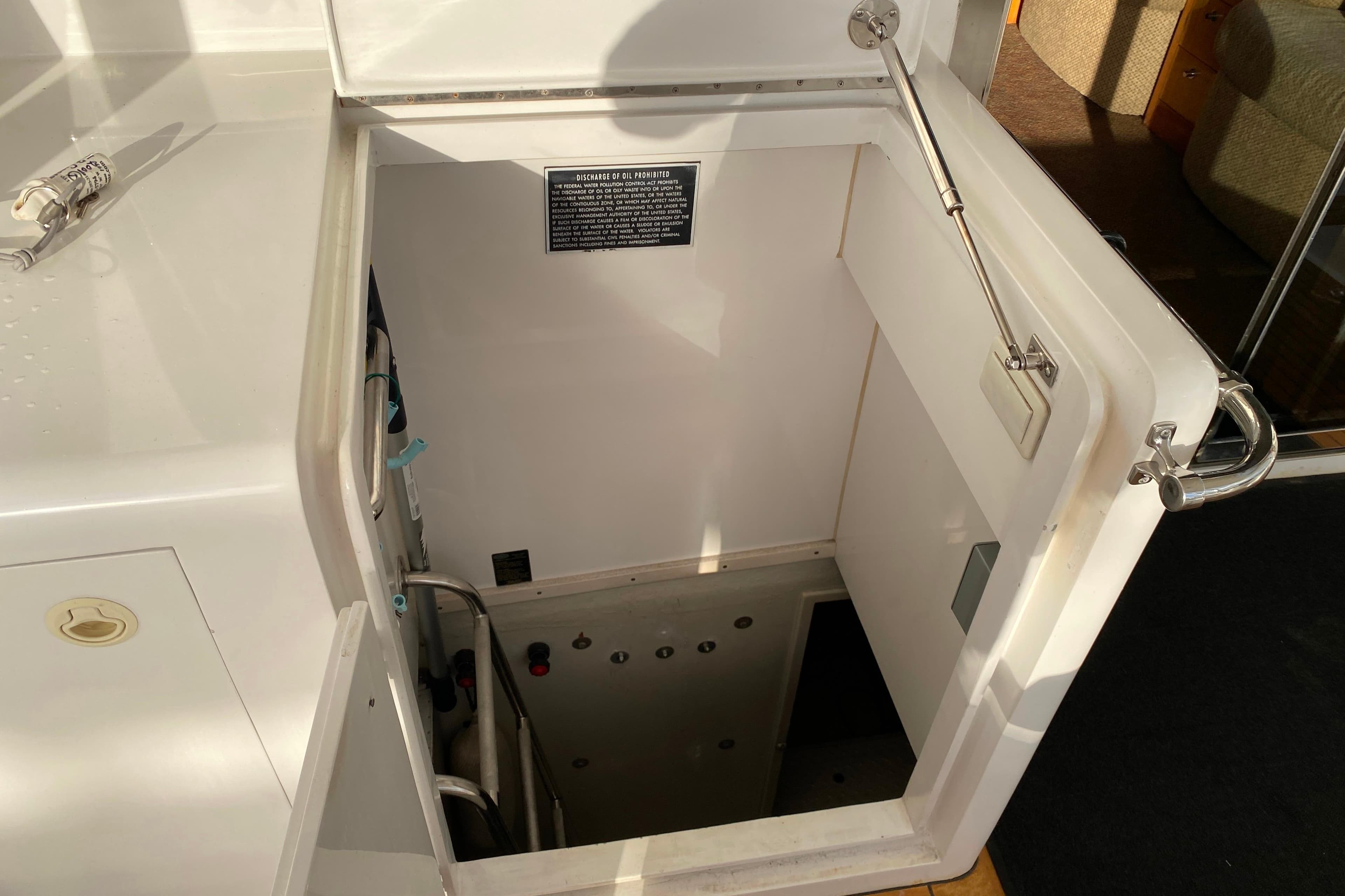 Engine room access hatch on a 2001 Compass 57 yacht, showing interior details.