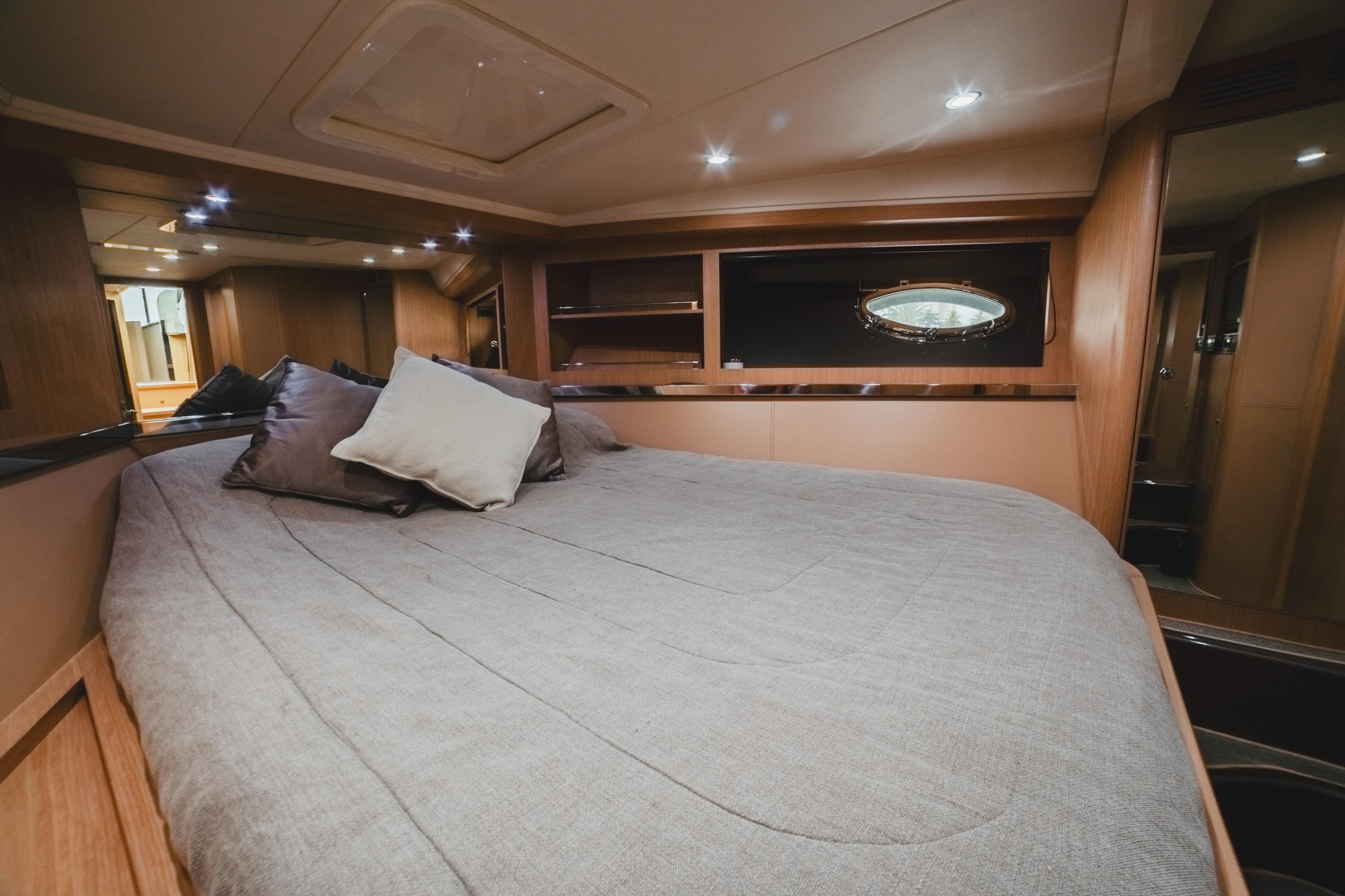 Luxurious cabin interior of 2011 Riva SportRiva 56 yacht with cozy bedding.