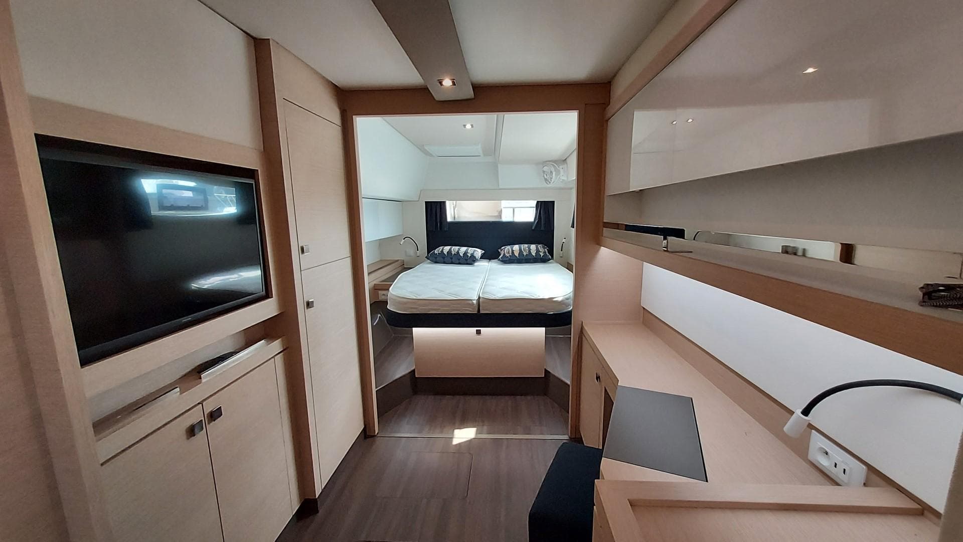 Luxurious interior of 2019 Fountaine Pajot Saona 47 catamaran with modern furnishings and cozy bedroom.