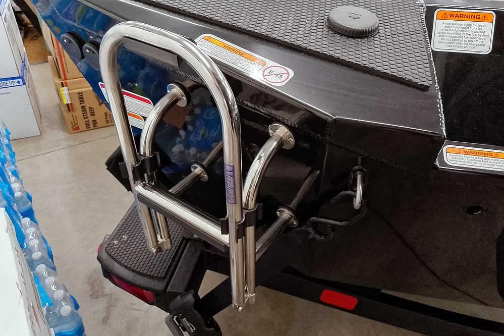 2026 Ranger RT188P boat with stainless steel boarding ladder and safety warnings.