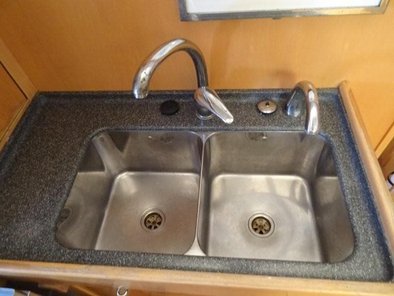 Stainless steel double sink in a 2000 Wauquiez 43 Pilot Saloon yacht kitchen.