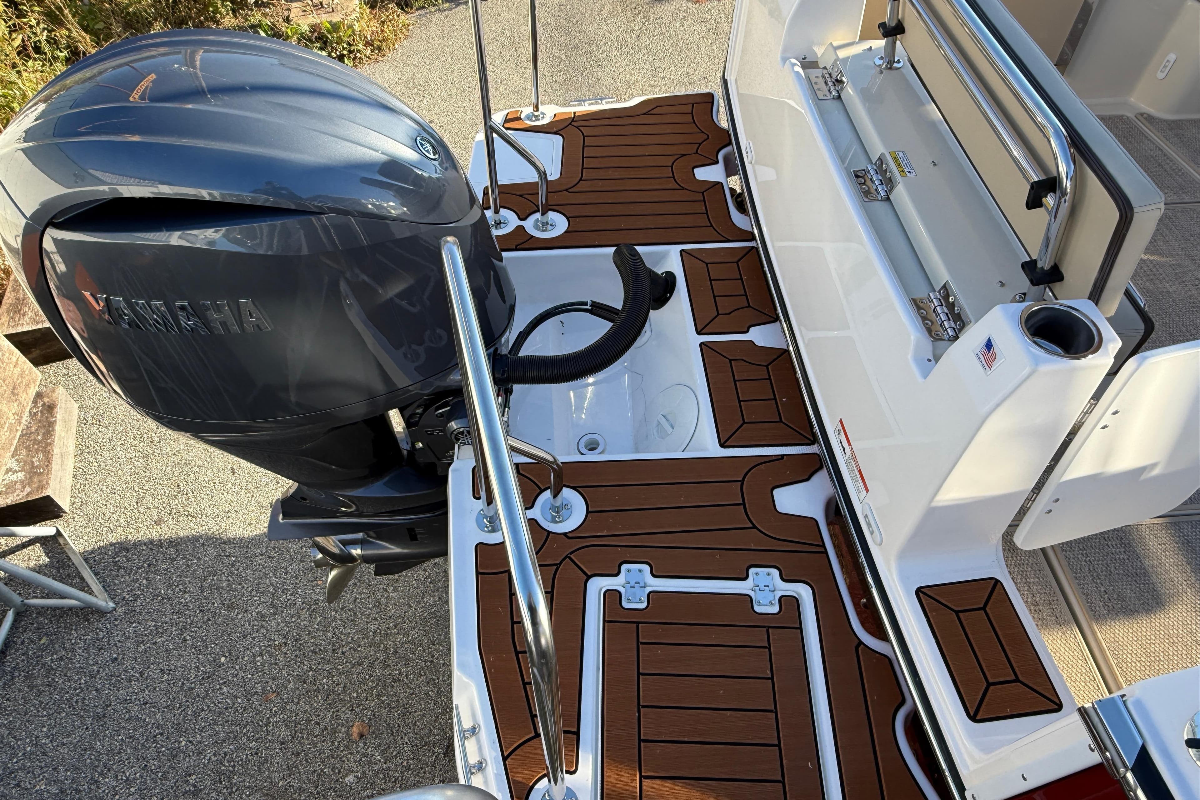 2026 Ranger Tugs R-23 boat with Yamaha outboard motor and teak-style deck.