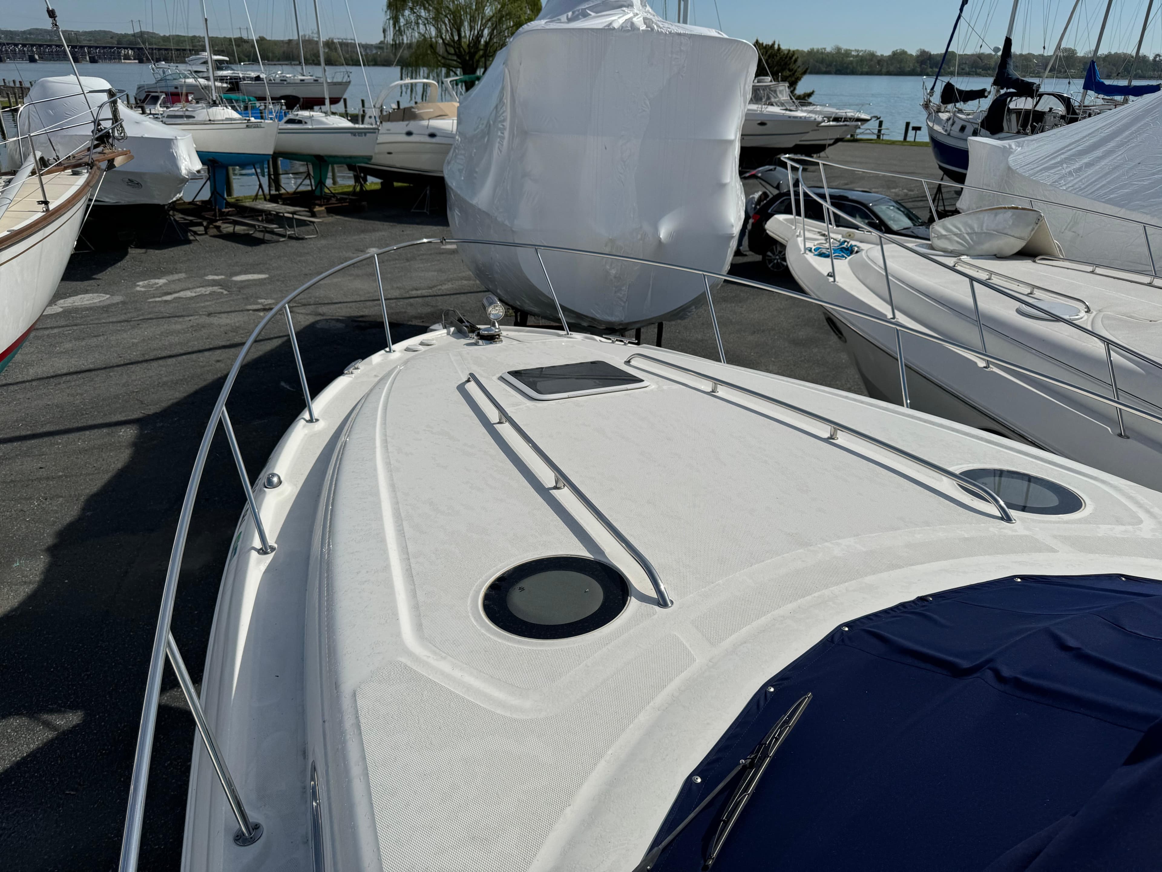 2006 Sea Ray 320 Sundancer boat docked with other boats in a marina.