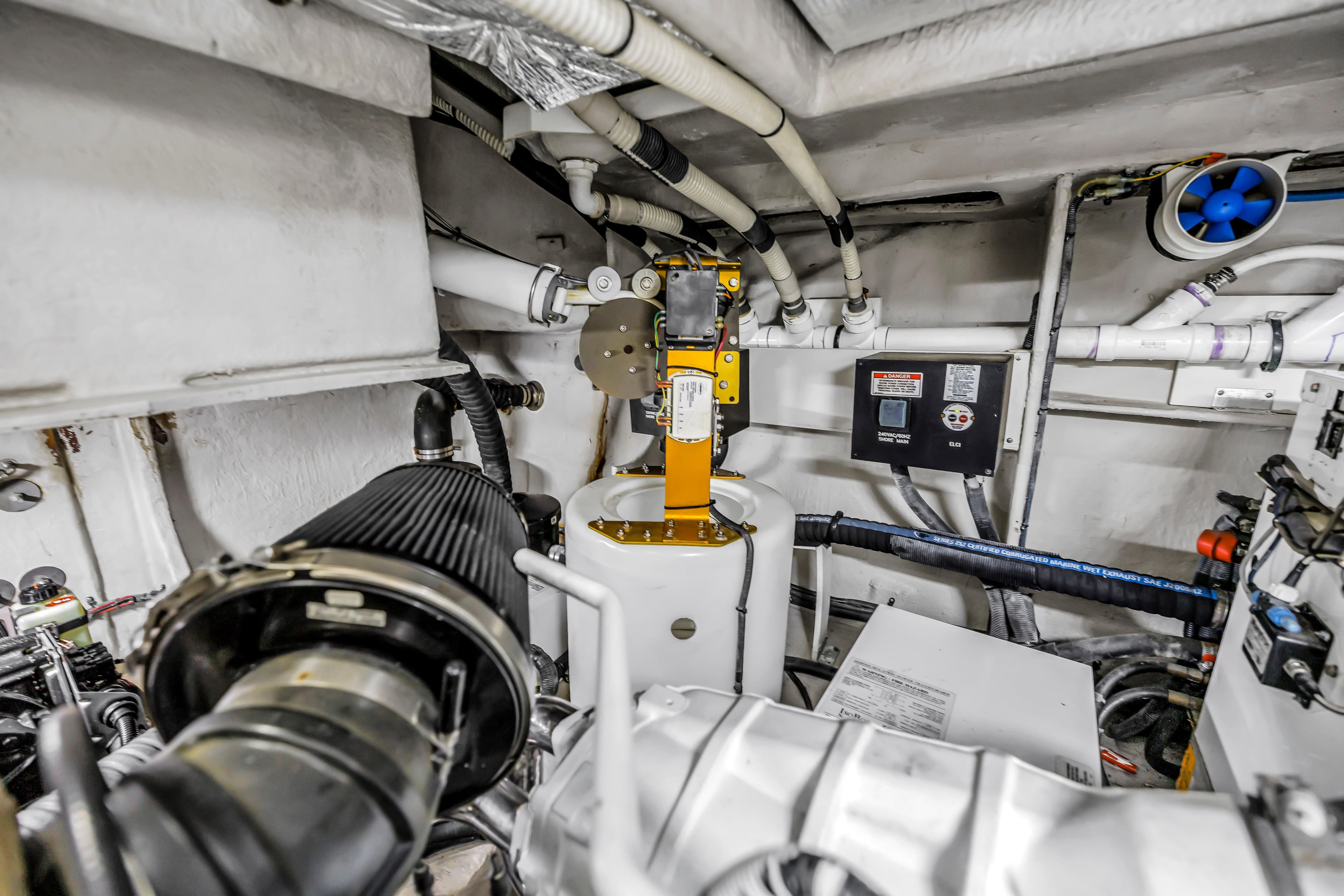 Engine room of a 2016 Sea Ray 510 Fly yacht, showcasing mechanical components and piping.